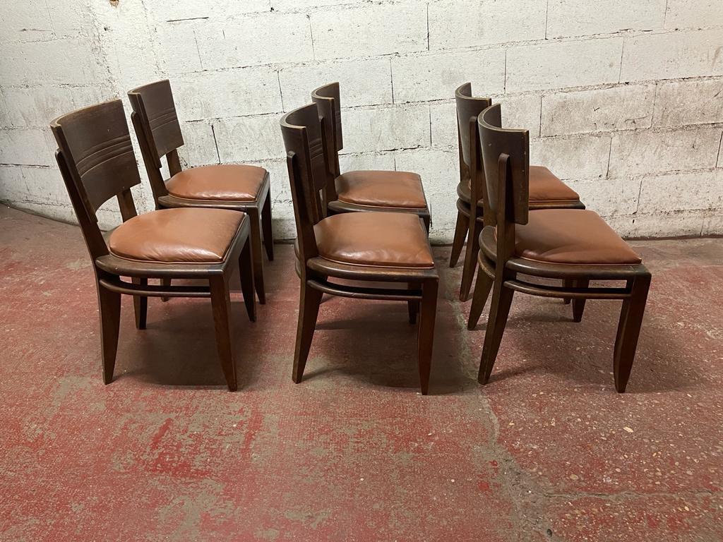 A set of 6 Dudouyt chairs in oak and leather seat.