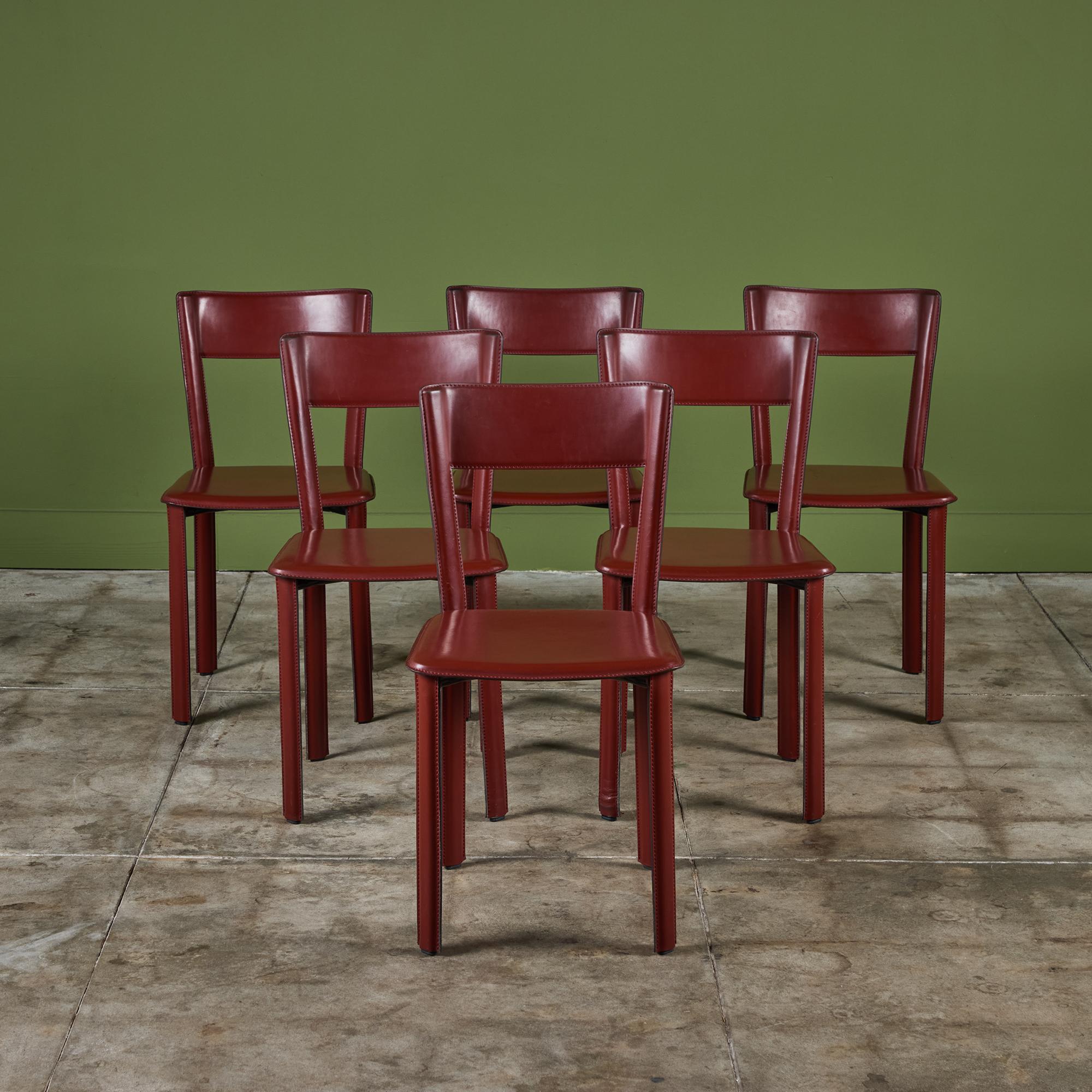 Set of six leather wrapped side dining chairs by Design Within Reach, reminiscent of Matteo Grassi or Mario Bellini. The set of chairs feature a red saddle leather which is wrapped atop a steel frame with stitched detailing.

Dimensions
16.25