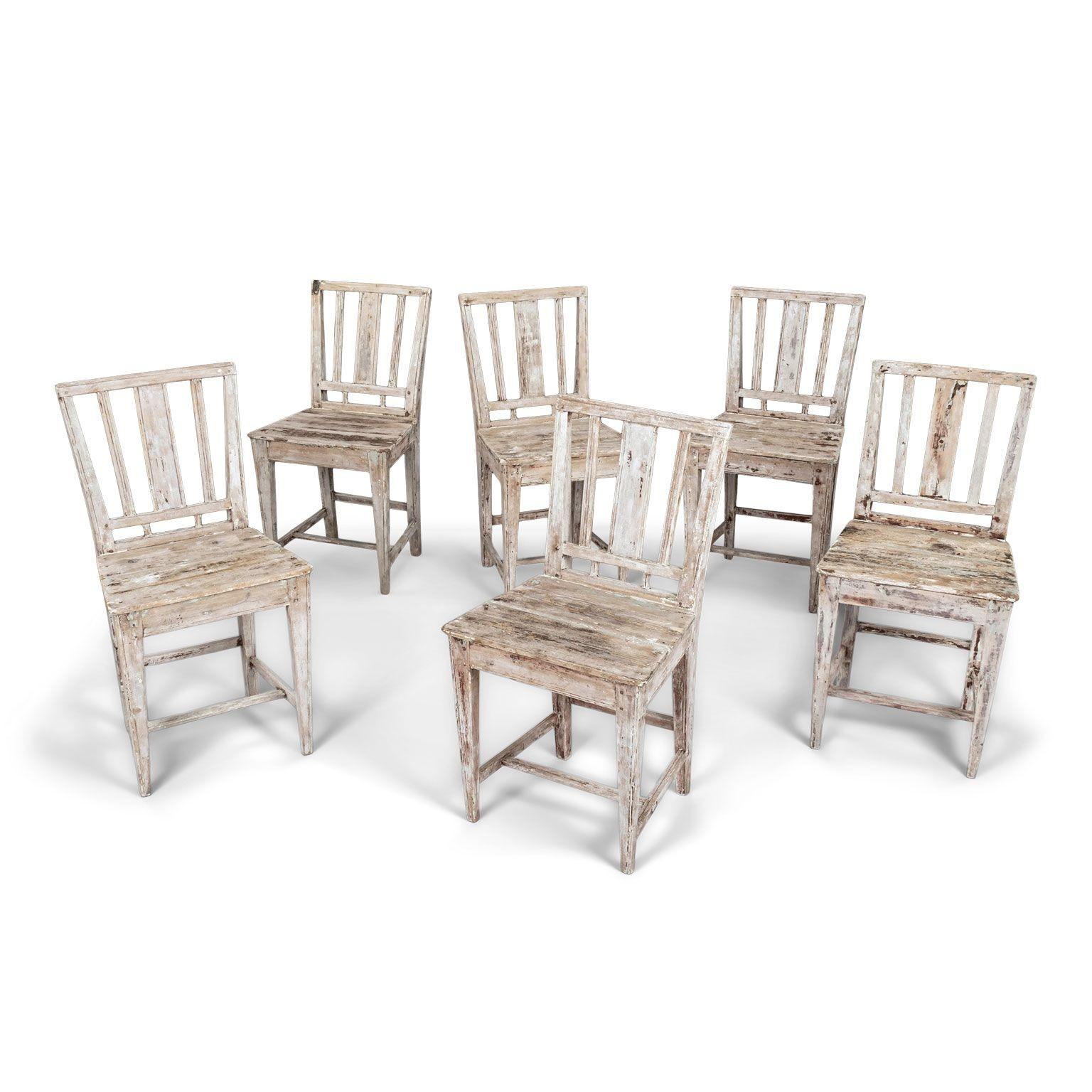 Set of six early 19th century painted Swedish farm dining chairs circa 1810-1829. Sturdy, stable. All joints tightened. No wobble. Remnants of old and early paint. Interesting steel repair on the upper back of one chair. Rustic neoclassical in