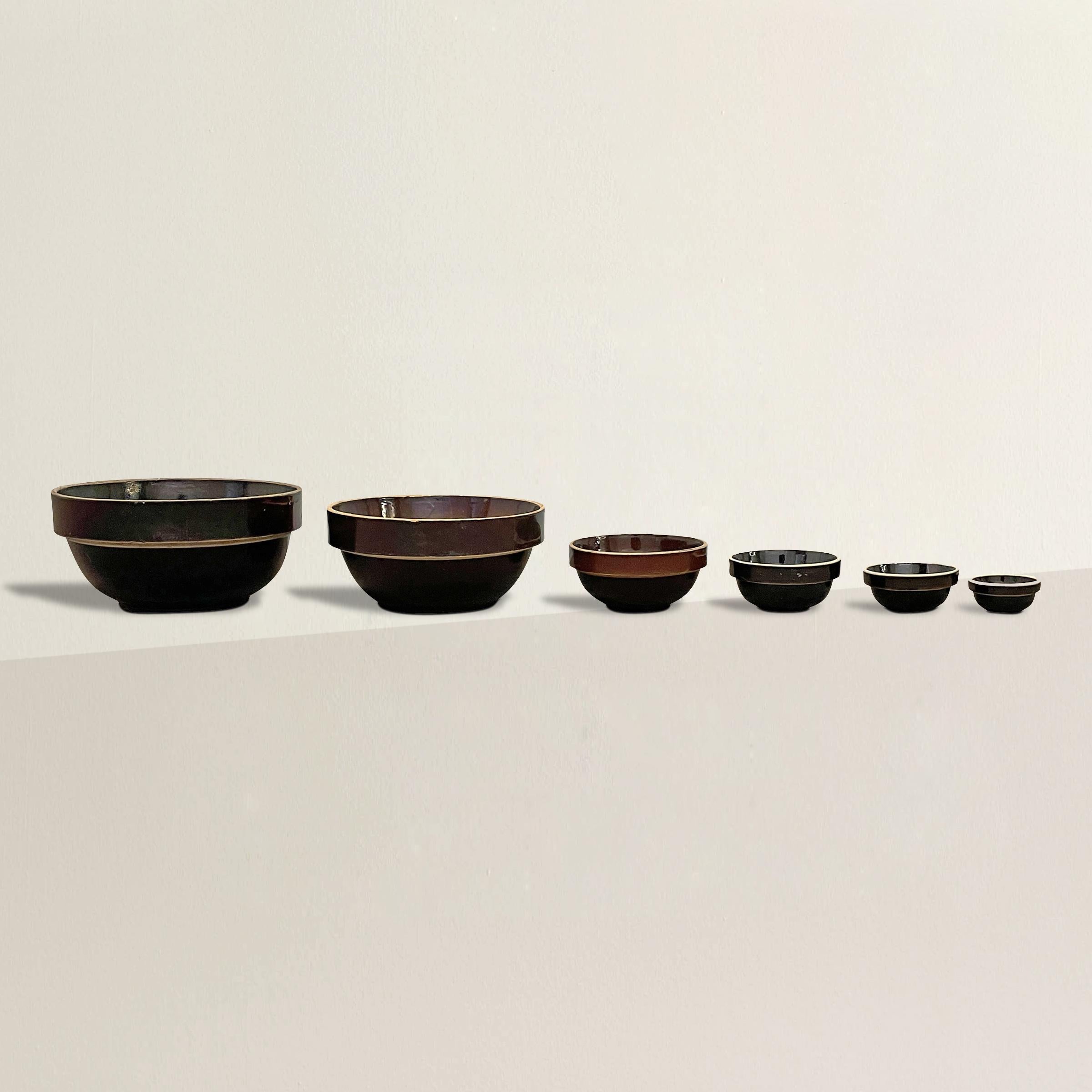 A lovely assembled set of six early 20th century American Albany-slip glazed stoneware mixing bowls of simple but sophisticated forms in varied brown colors. The perfect blend of function and style!

XS: 3.25 in. diameter x 1.75 in. height
S: 4.5