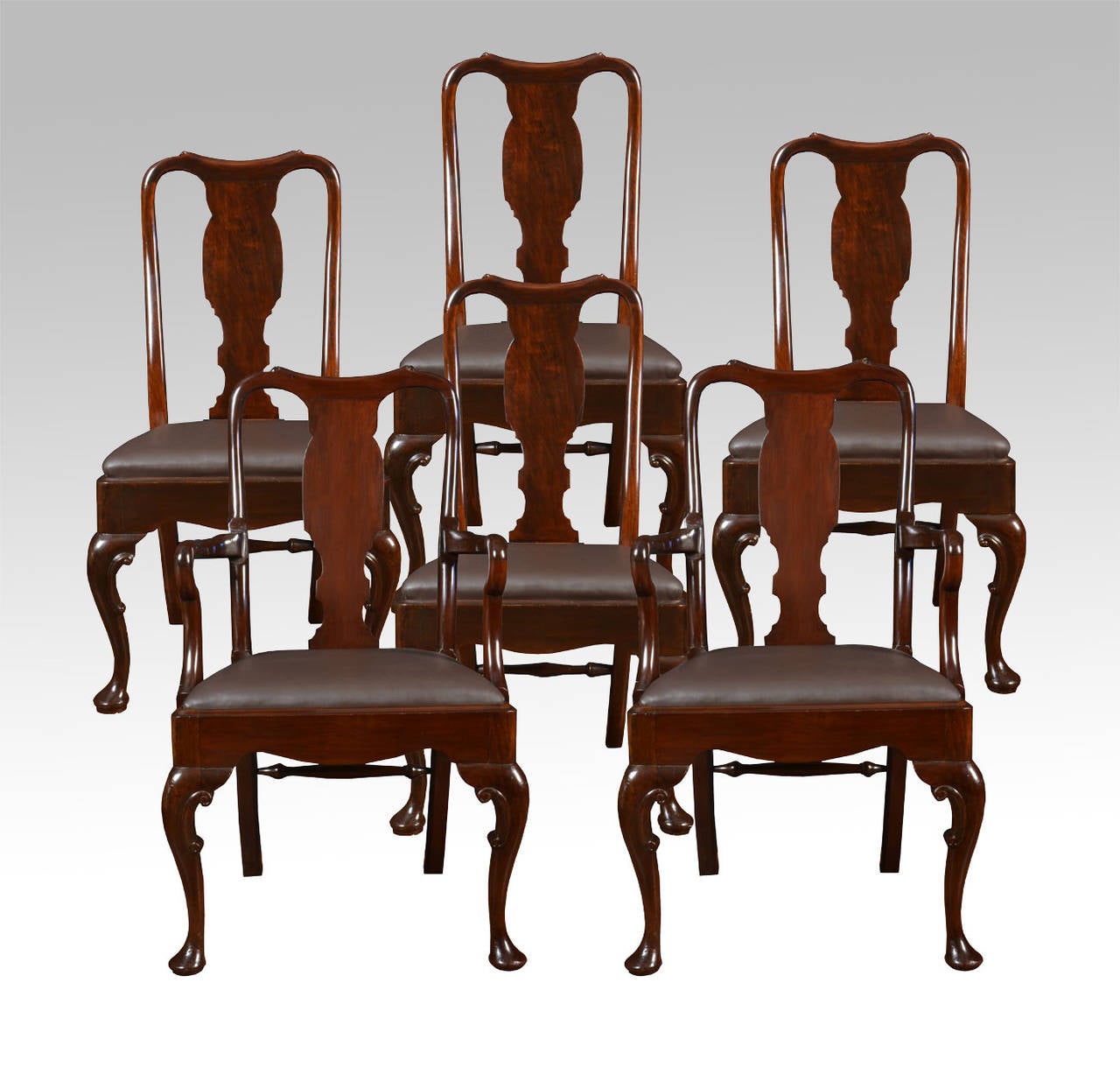 Set of six early 20th century Queen Anne style high back dining chairs, having vase shaped back splat, drop-in seat and standing on cabriole supports united by turned rear stretcher, two carvers and four chairs

Measures: Carvers

Height 43