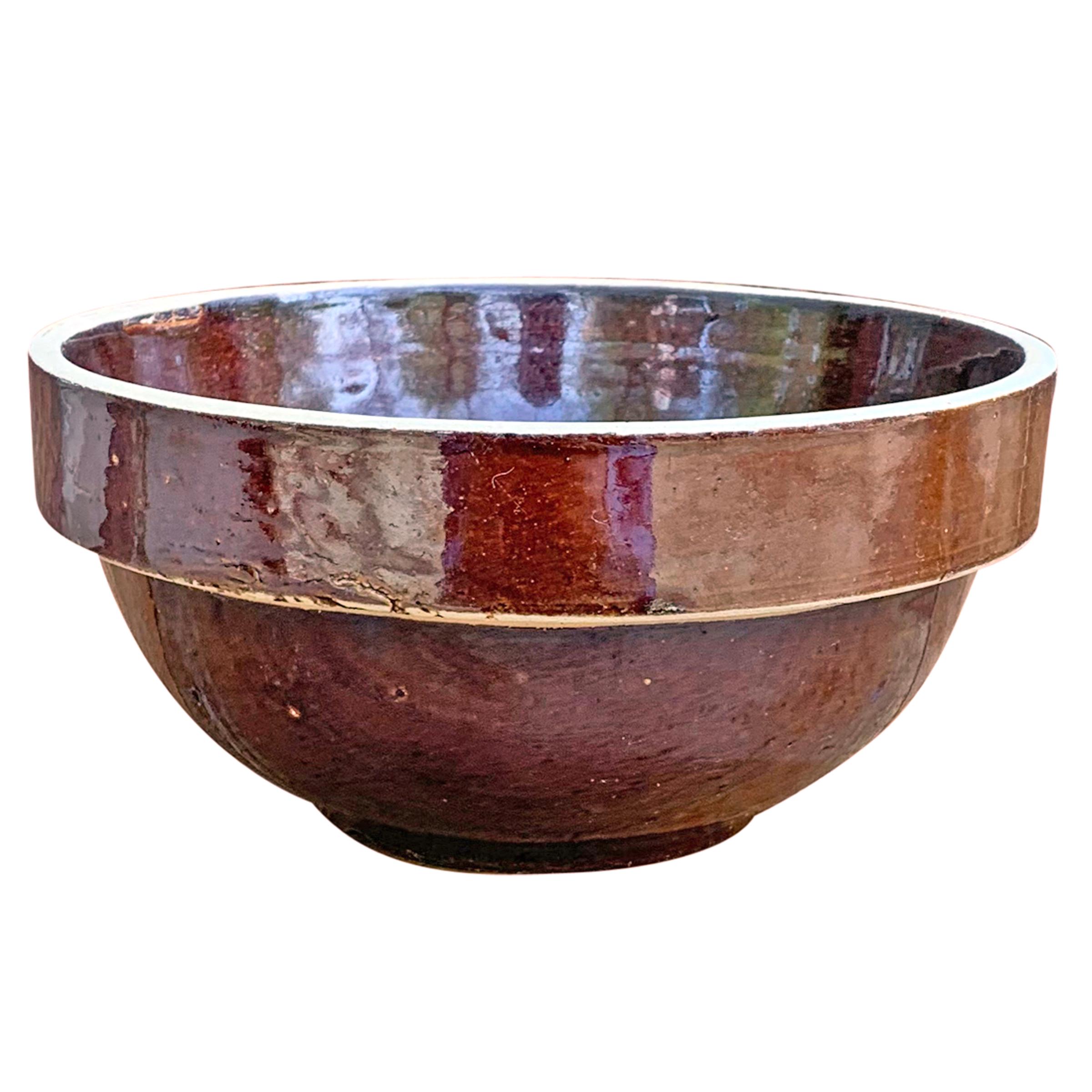 A lovely assembled set of six early 20th century American glazed stoneware mixing bowls of simple, but sophisticated, forms in varied brown and grey colors. The extra large bowl is marked, 