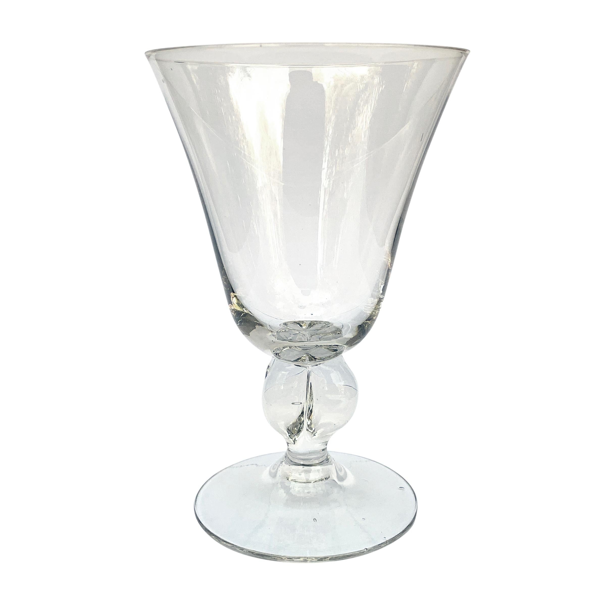 A set of six chic early 20th century Swedish hand blown crystal wine glasses with bell-curved bowls resting on quatrefoil stems. The walls of the bowls are thin showing a high degree of skill in their creation.