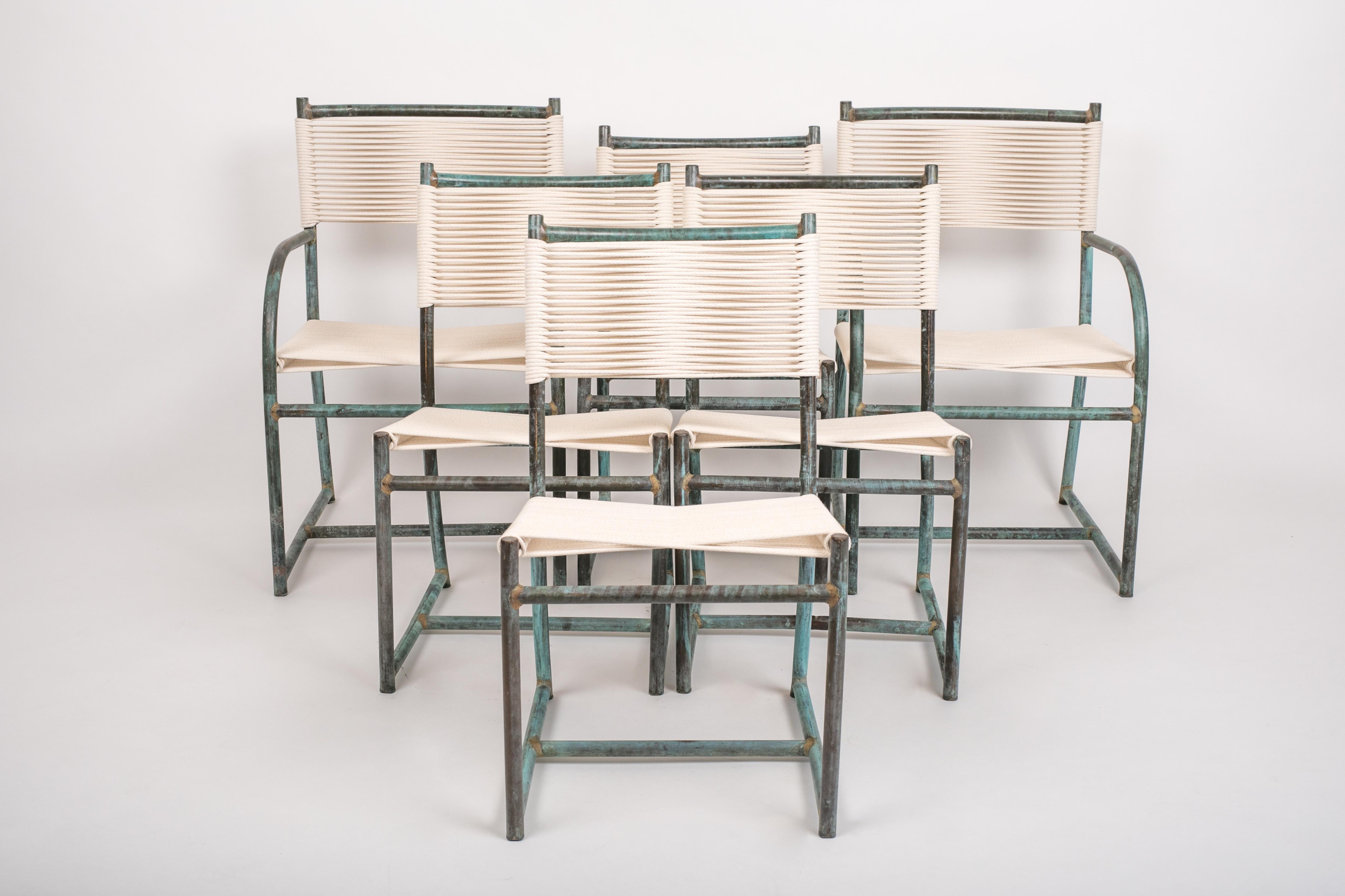 A set of six dining chairs by Walter Lamb dating from the late 1940s to early 1950s from the initial years of his work with Brown Jordan.  The set Includes two ‘captain’ chairs with armrests and four simple dining chairs, without armrests.  Each