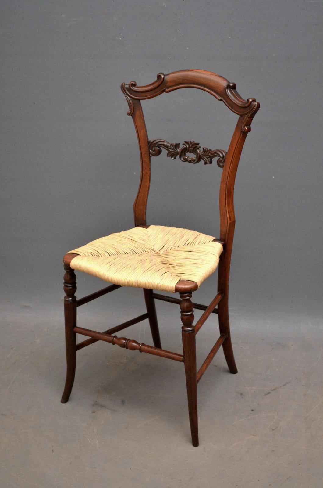 Sn863, a fine set of six early Victorian solid rosewood chairs, having carved shaped top rail with decorative carved mid rail and new rush seats, standing on slim elegant turned and outswept leg with double stretchers. This set of antique chairs