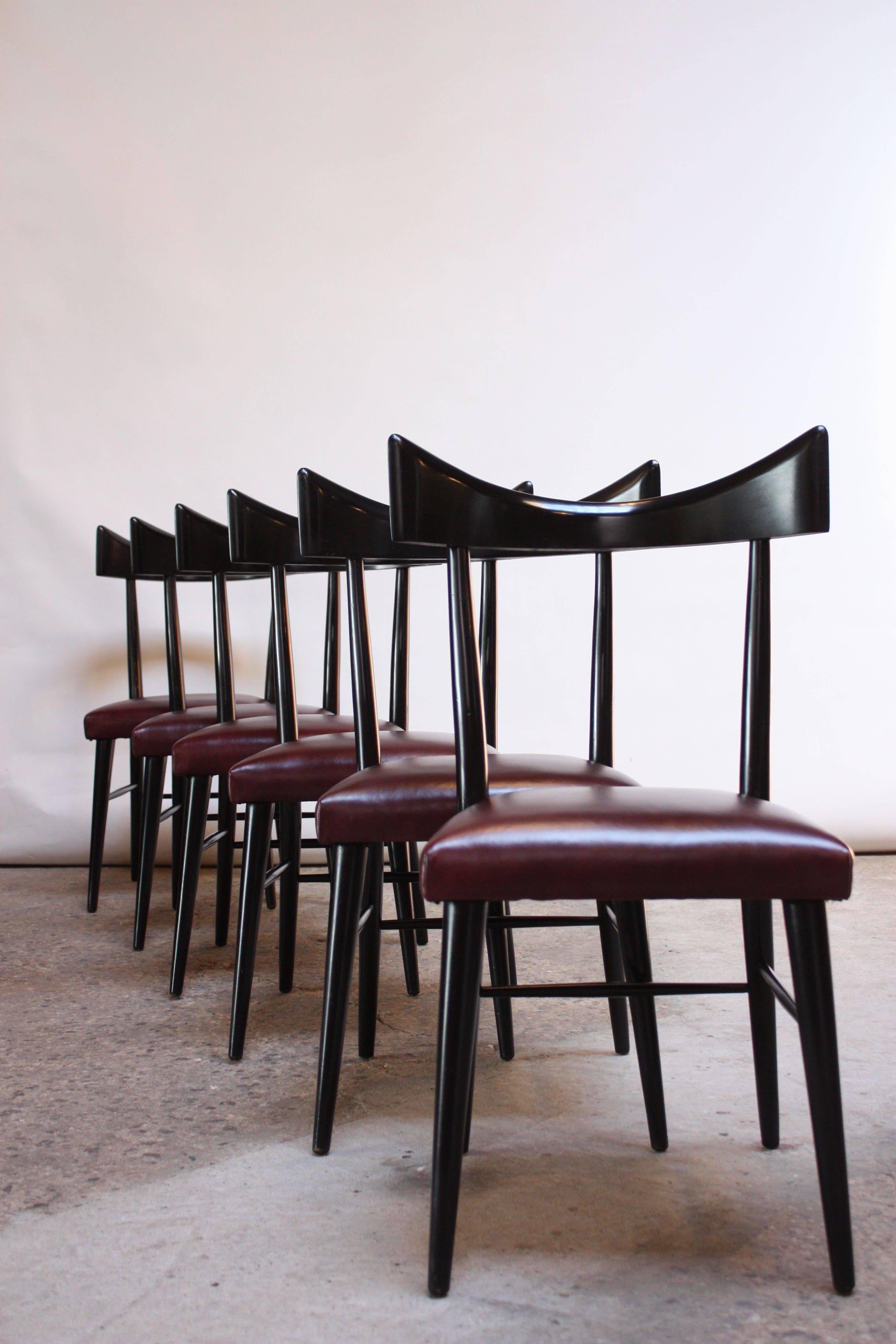 Set of six Paul McCobb 'Planner Group' bow-back dining chairs for Winchendon. Solid maple construction in original black lacquer paired with mauve leather seats. Simple, elegant bow-back design with sculptural form and clean lines