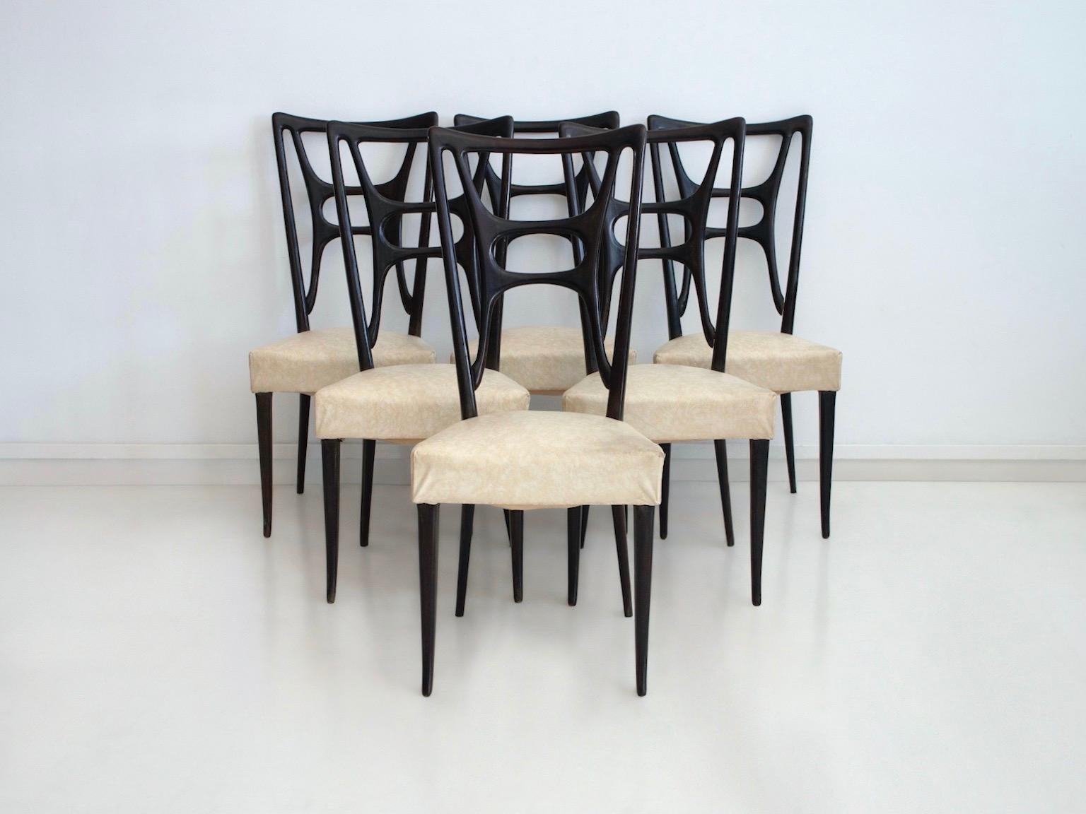 Set of six chairs made in Italy, circa 1950. Beautiful ebonized wood back and structure, upholstered seats covered in imitation leather. Some discoloration and stains on upholstery, broken corners.