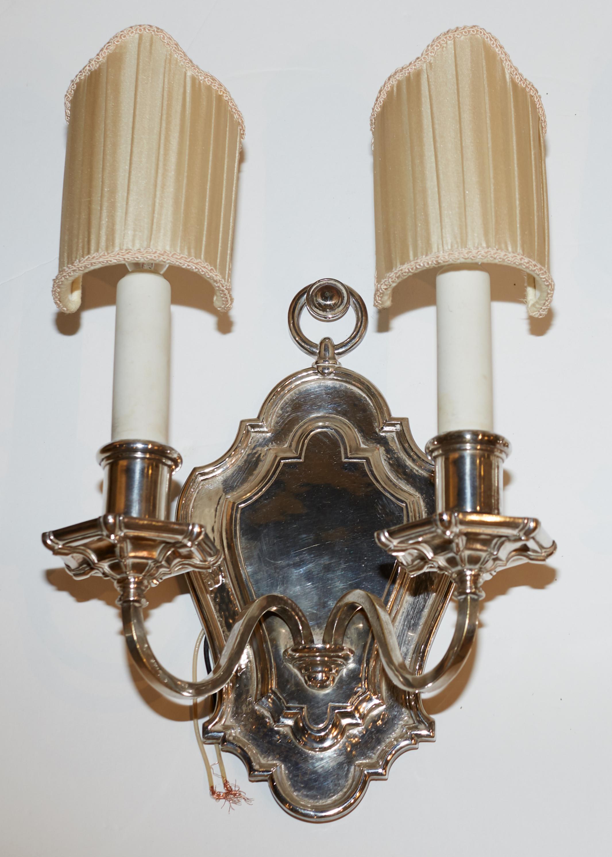 Set of six (Three pairs) of silvered bronze shield back sconces by Edward F. Caldwell.