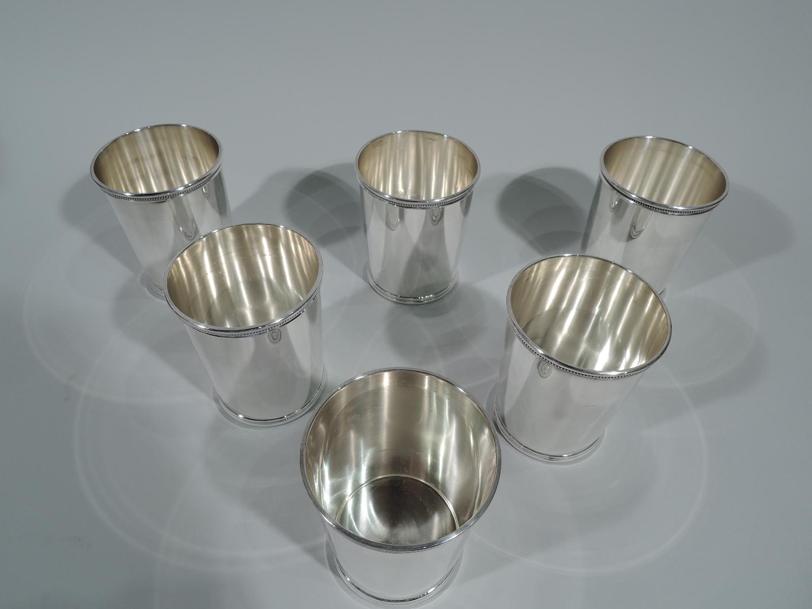 Set of six sterling silver mint julep cups. Retailed by Scearce in Shelbyville, Kentucky. Each: Straight and tapering sides and beaded and molded rims. Fully marked including presidential date code DDE for Dwight David Eisenhower, who was in office