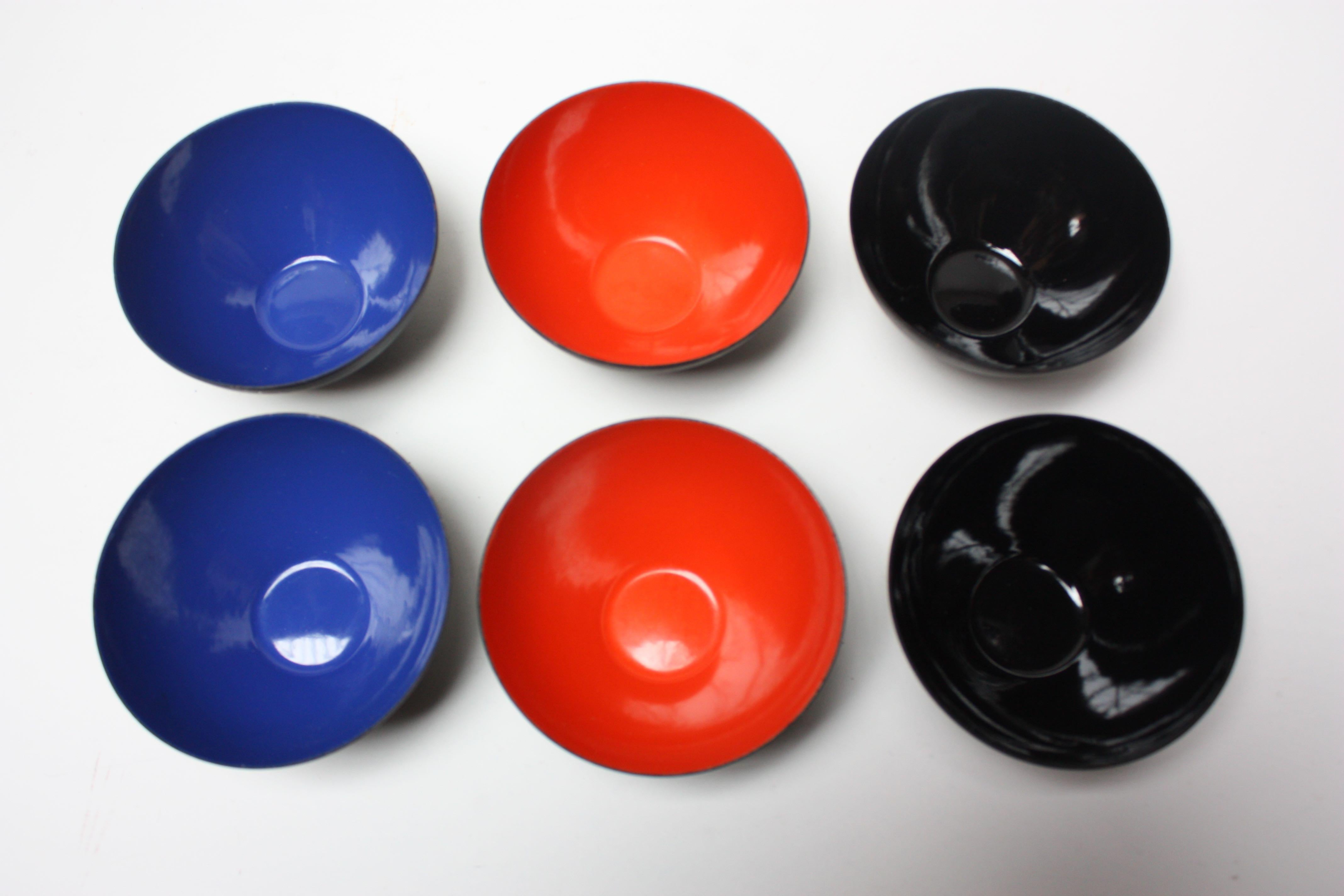 Set of six 1970s Krenit snack bowls by Herbert Krenchel. Black metal with blue, black and orange enamel interiors. (Set comes as two of each color.)
Small size (5