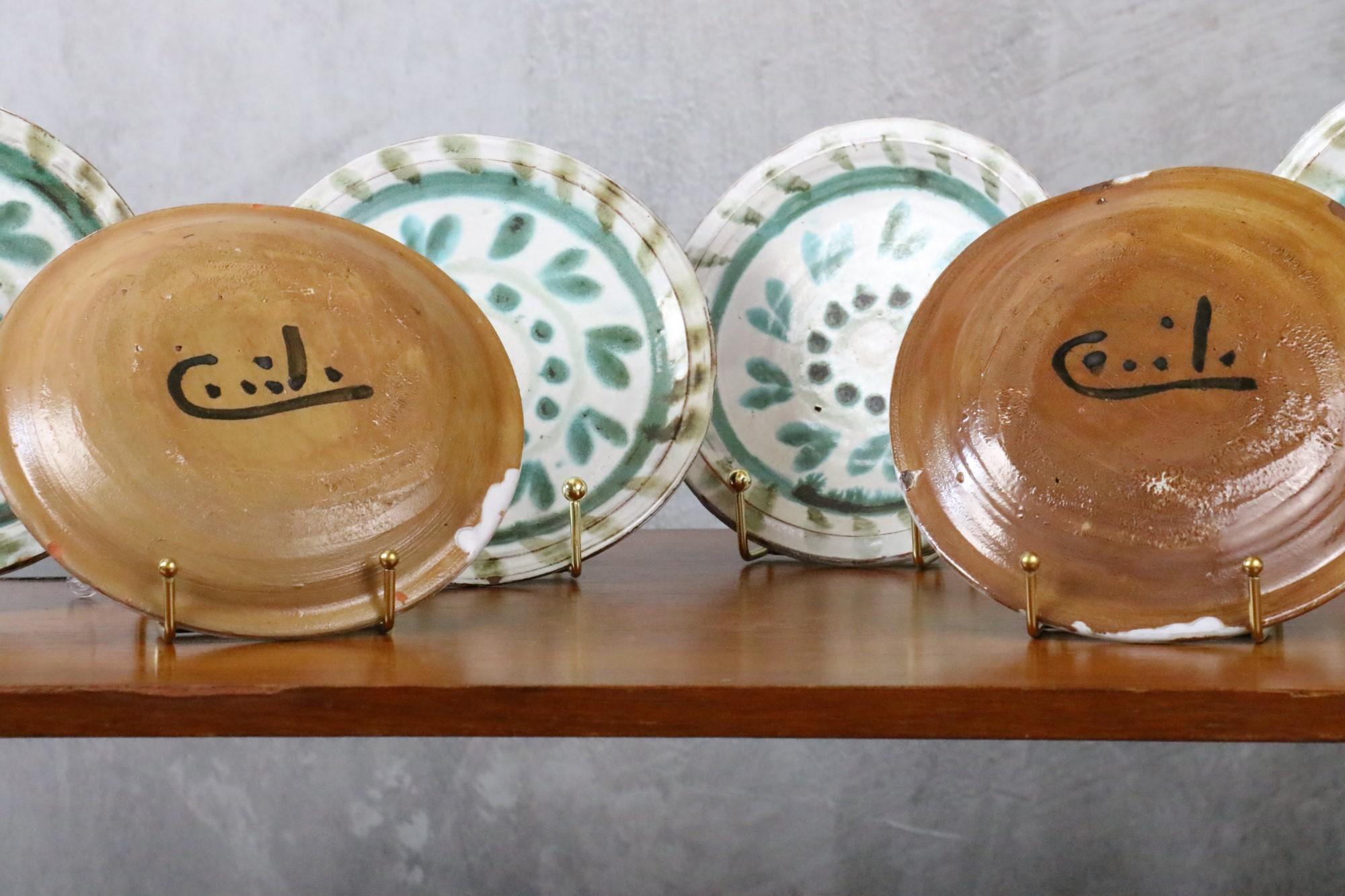 Set of six enamelled plates by Cécile Dein, French ceramist. Circa 1960. 
Decorative plates, they are signed on the bottom. Handmade, they are not perfectly flat. They have a few small chips but are in good condition. 

Born in 1929, Cécile Dein