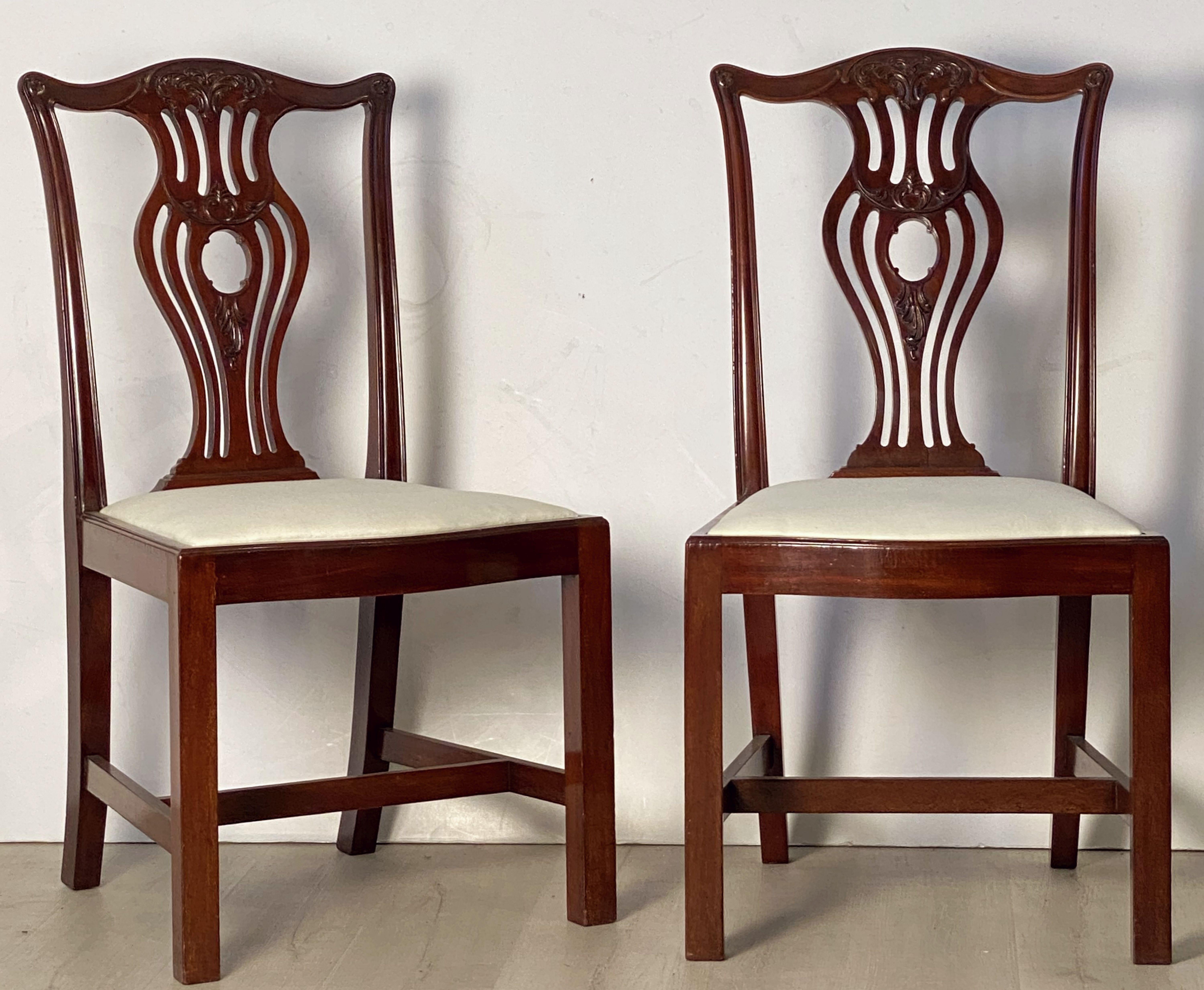 A handsome set of six English dining chairs of mahogany in the Art Nouveau style.
Each chair featuring a carved mahogany back and a comfortable upholstered seat.

Seats are removable.