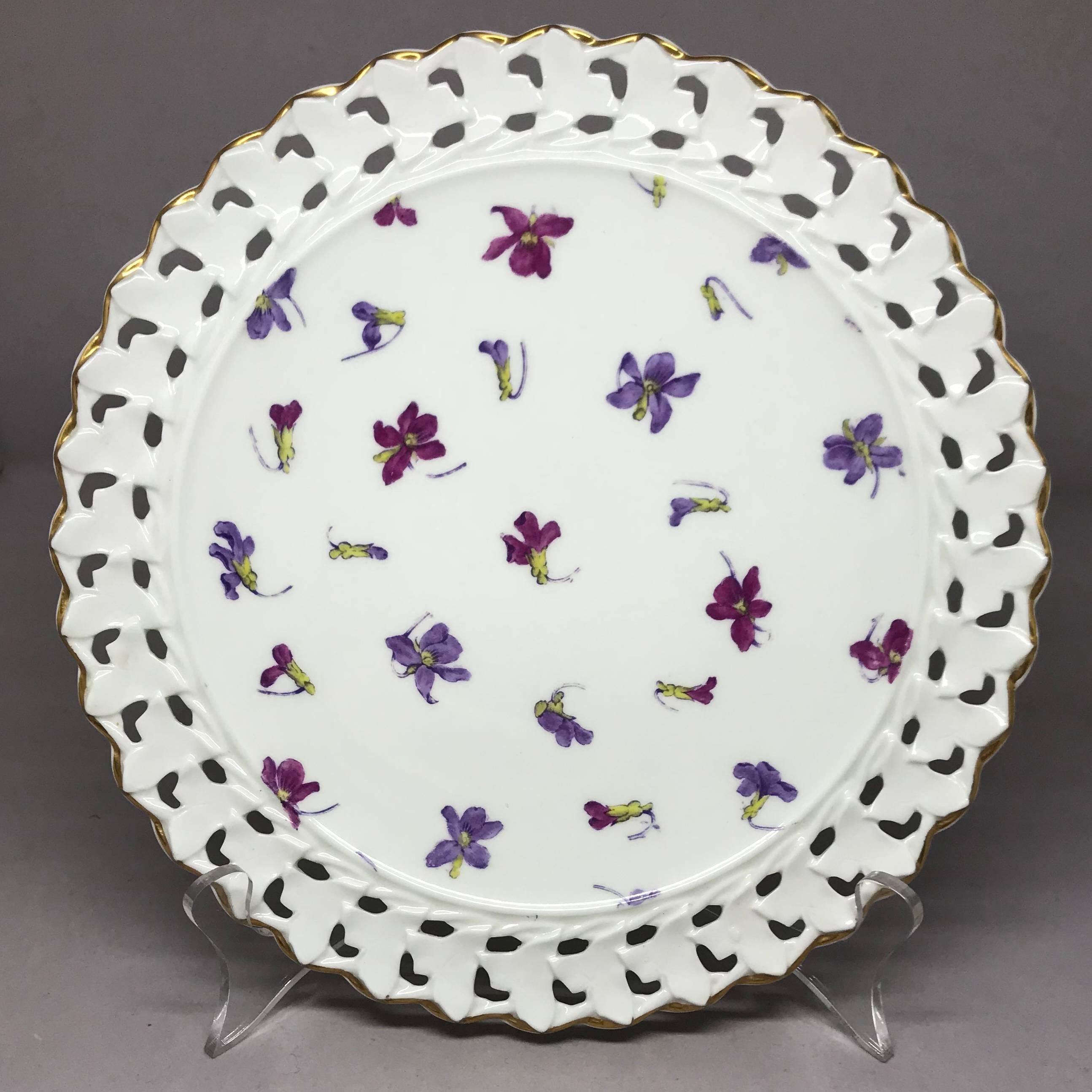 Set of six pink and purple floral gilt plates. Six white plates decorated with purple and magenta floral sprays bordered in reticulated gold rims.  Marks for Cauldon. England, early 20th century.
Dimensions: 9.5