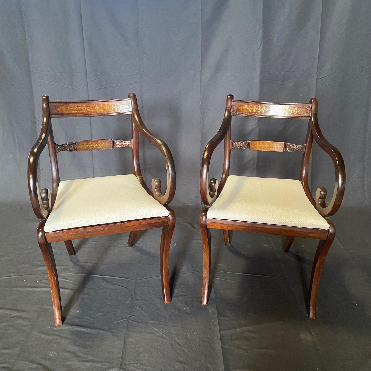 A superb British set of six brass inlaid Regency Revival dining chairs, of well-shaped Klismos outline, dating from the early 20th century. These chairs have been masterfully hand crafted with decorative brass inlay to the backs in beautiful solid