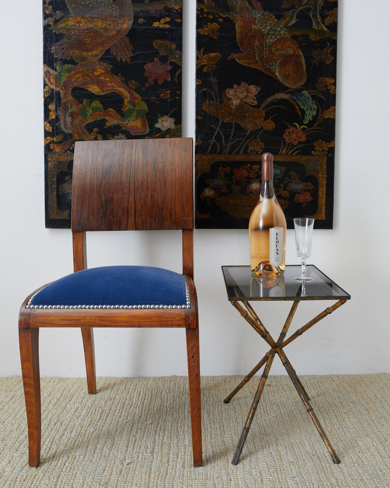 Exquisite set of six English dining chairs made in the Regency taste. The chairs feature a square back constructed from radiant grained rosewood with dramatic patterns in the wood. The seats are upholstered with a deep sapphire blue velvet fabric