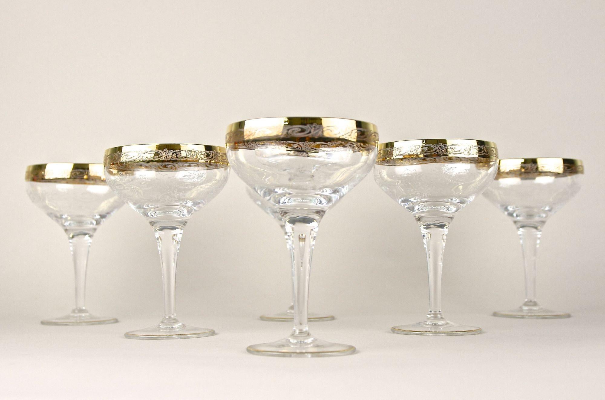 Marvelous set of six Murano champagne glasses from the early mid 20th century in Italy around 1940. These outstanding designed Italian champagne coupe glasses impress with an absolute noble design adorned by beautiful ornamental engravings. The