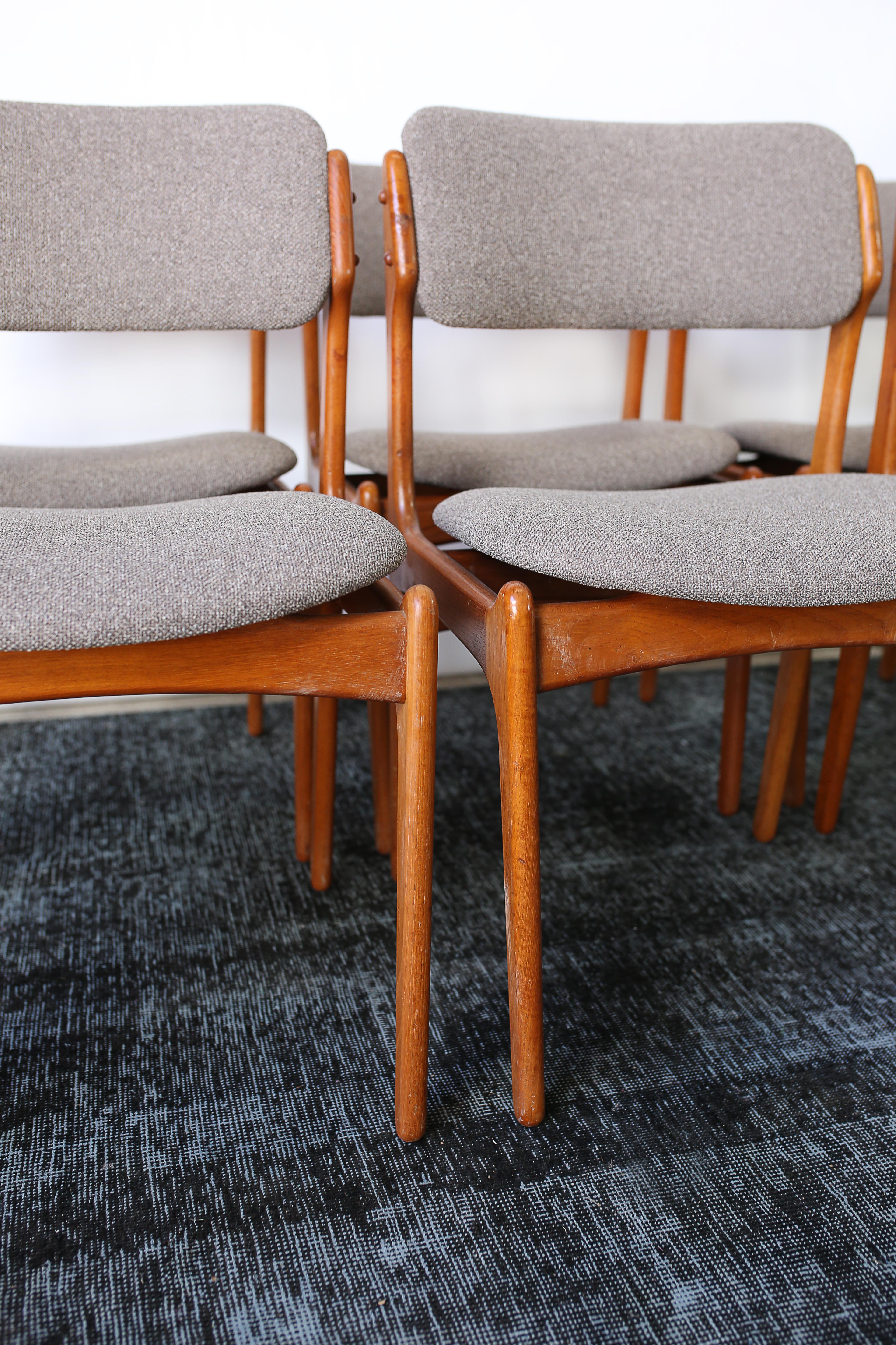 This set of six Model 49 dining chairs designed by Erik Buch for Oddense Maskinsnedkeri are in overall good condition and wear consistent with age and use.  Solid teak construction.  Original grey tweed upholstery.  A warm amber glow throughout the