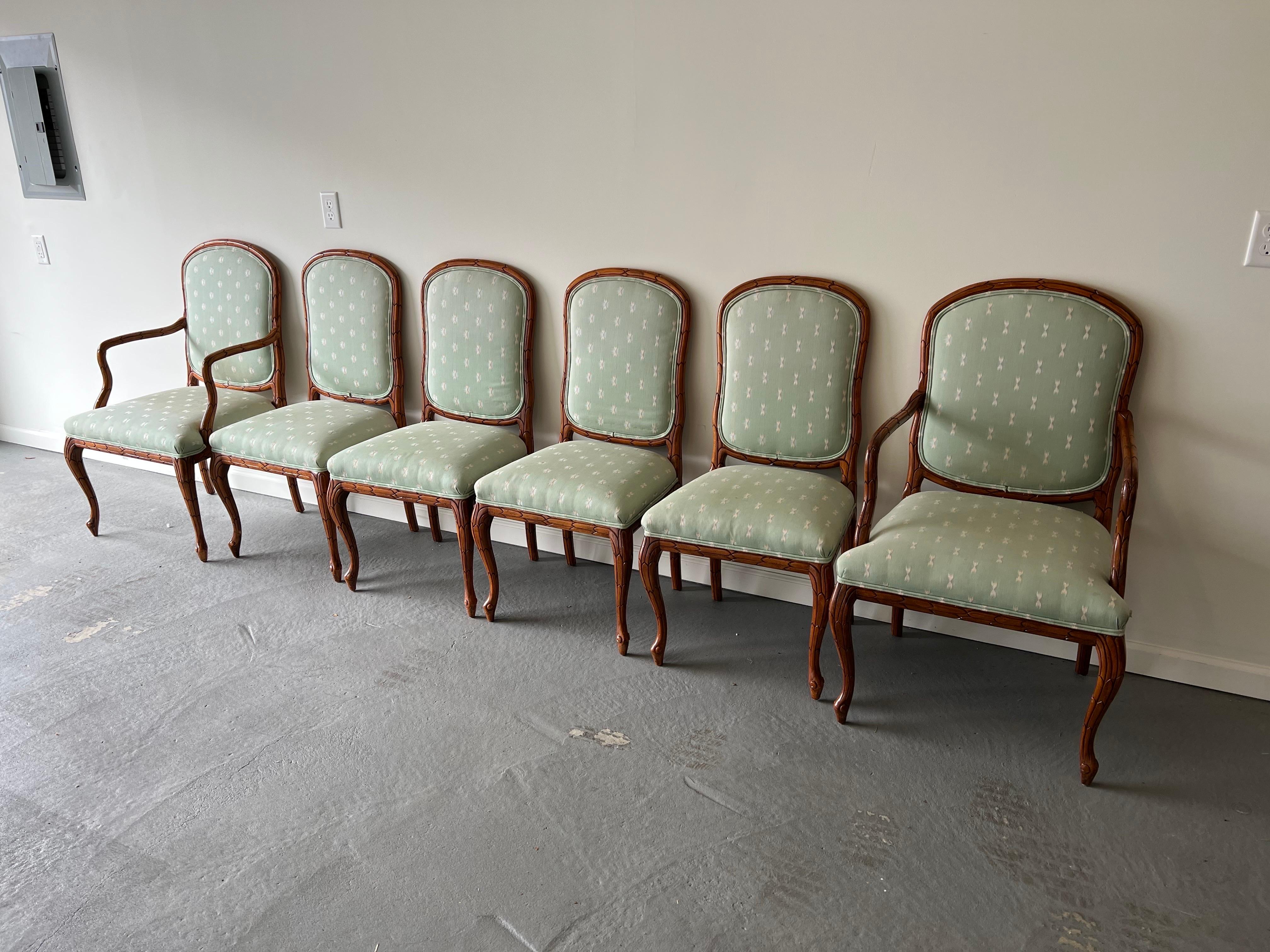 Set of Six Solid Wood Carved Dining chairs, two arm, four side. In the Faux Bois style this set features striking carved feather-like detail throughout the wooden base with custom pale green upholstery and double welted trim. Perfect for the