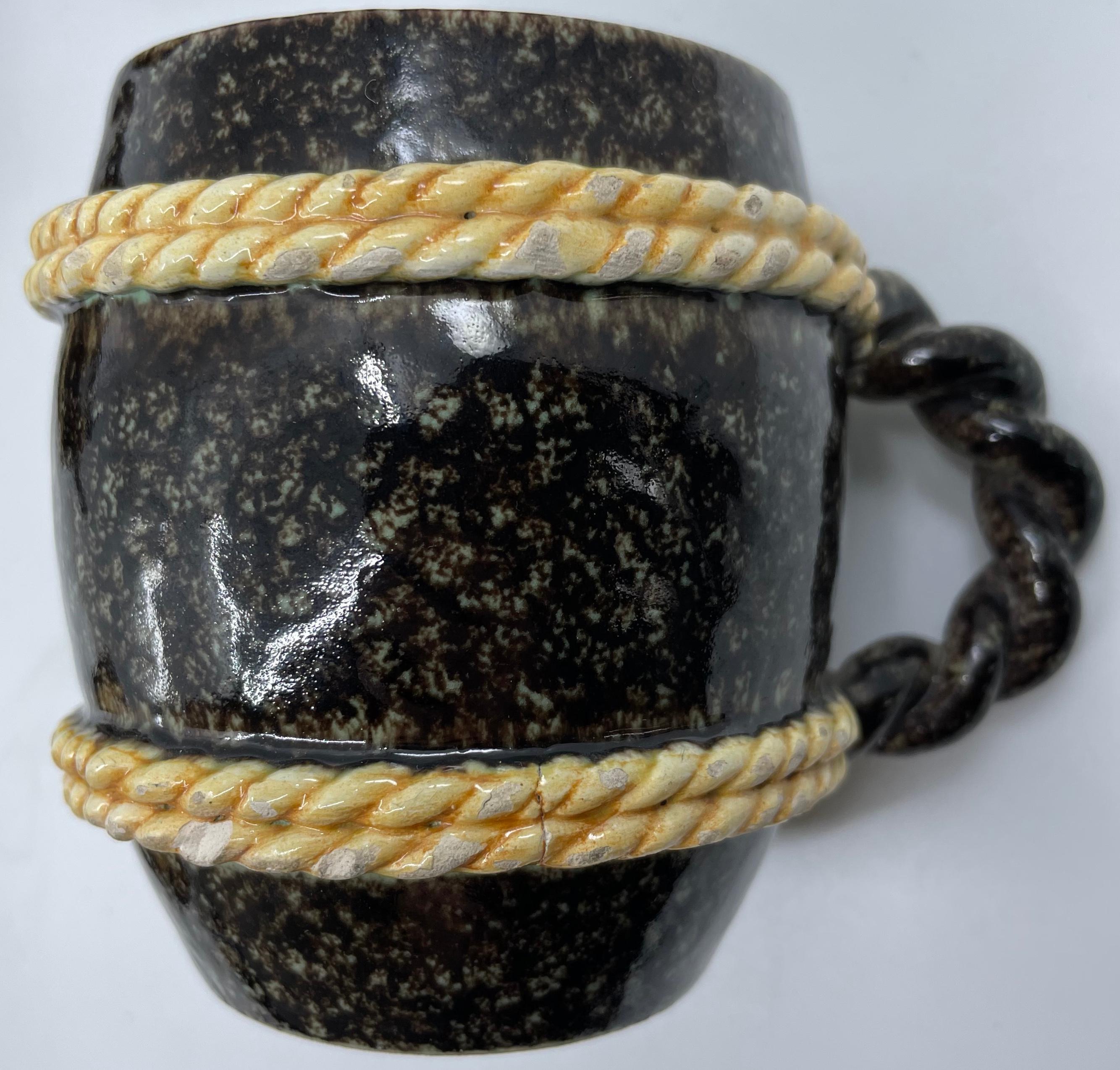 Set of six faux porphyry mugs. Six unique hand cast majolica nautical cups/mugs in faux porphyry glaze with celadon blue interior wash and contrasting “rope” trim. Markings for Caltagirone. Italy, late 19th century.
Dimensions: 3.5