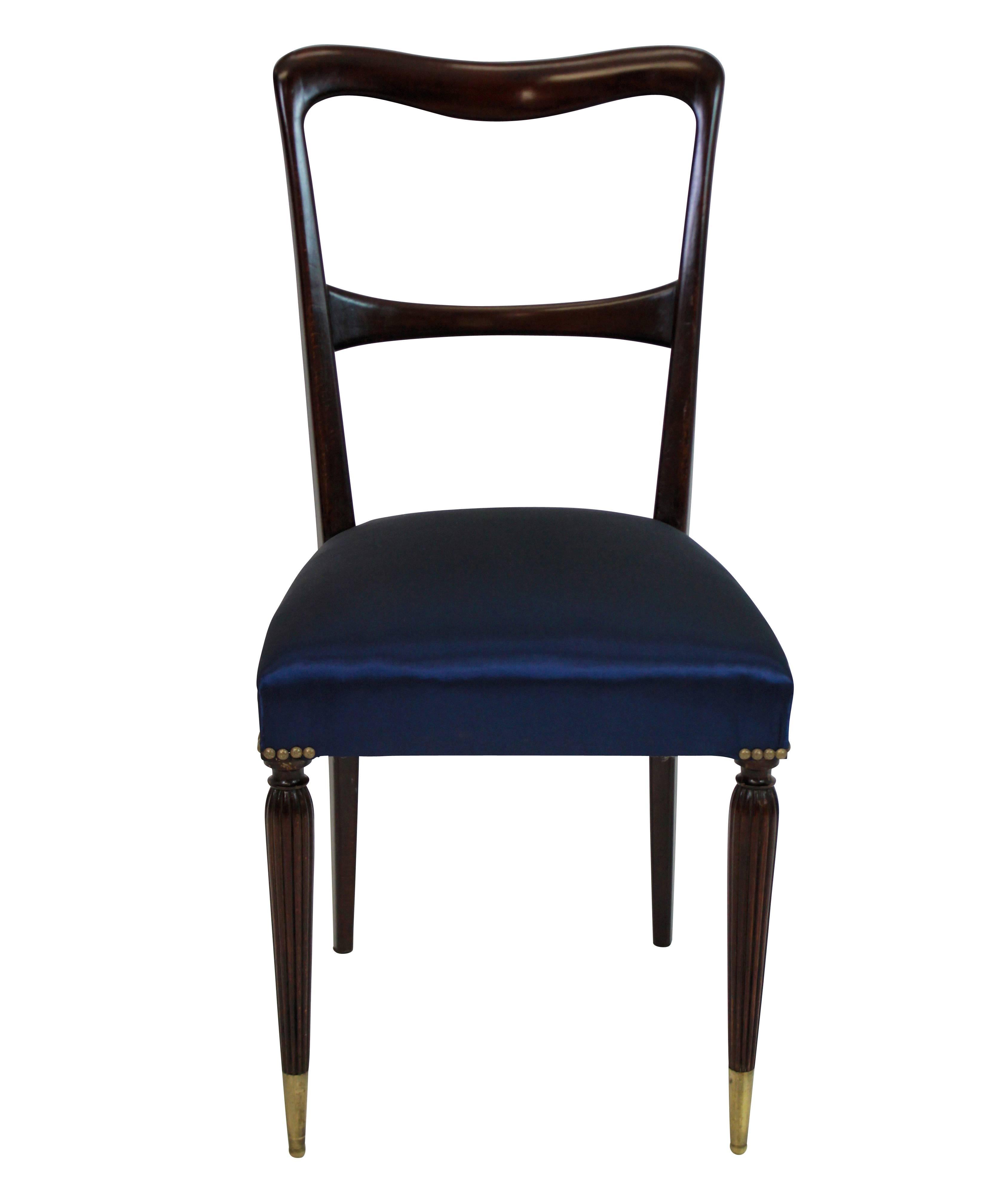A set of six fine quality Italian midcentury dining chairs in stained beech, with sculptural backs, long brass sabot feet and newly upholstered in deep blue silk.

   