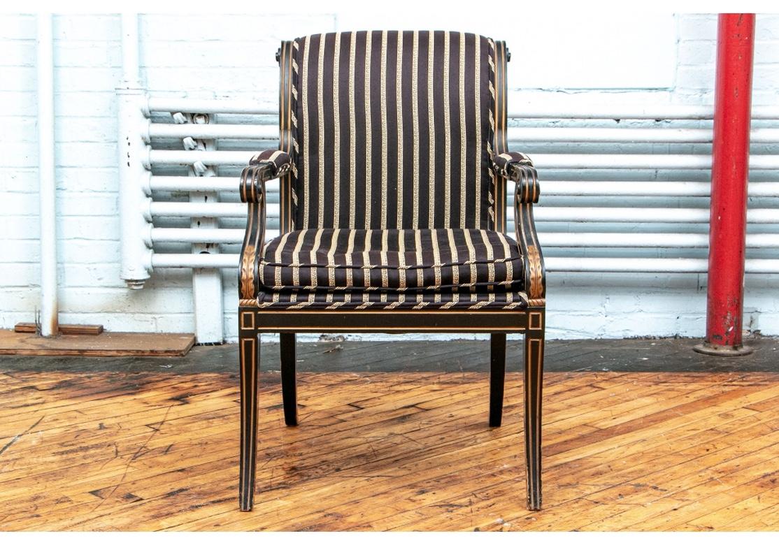 Fine set of chairs with scrolled classical backs and arms, two armchairs and four side chairs. Carved ebonized and gilt banded frames, upholstered in fine black and gilt Greek key pattern silky fabric. With separate seat cushions.
Measures: Height