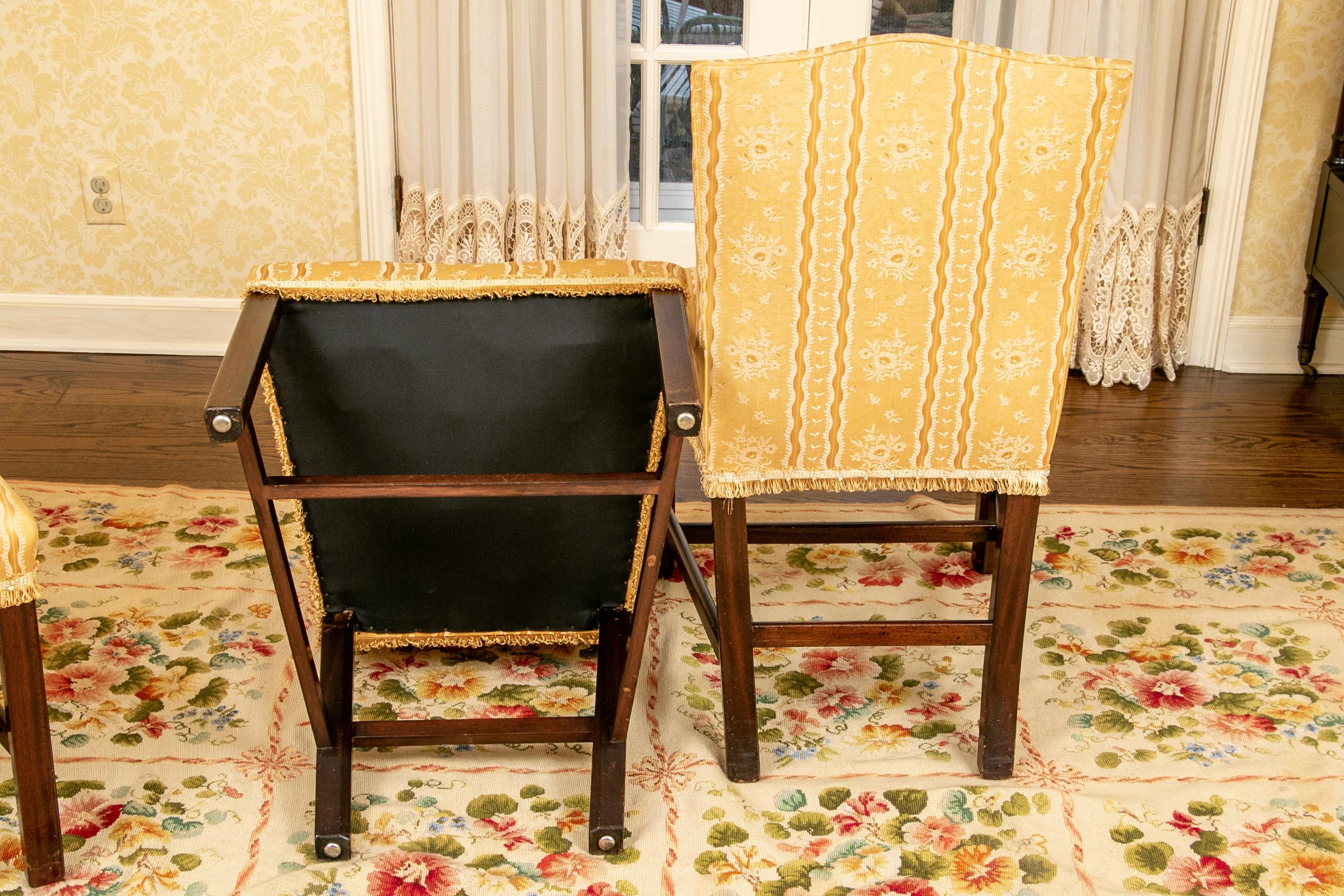 All side chairs. Mahogany frames with square legs and stretchers on all sides. Upholstered in a silky yellow floral stripe fabric. 

Condition: Good condition with a few spots to the seats, some expected scrapes to the legs.