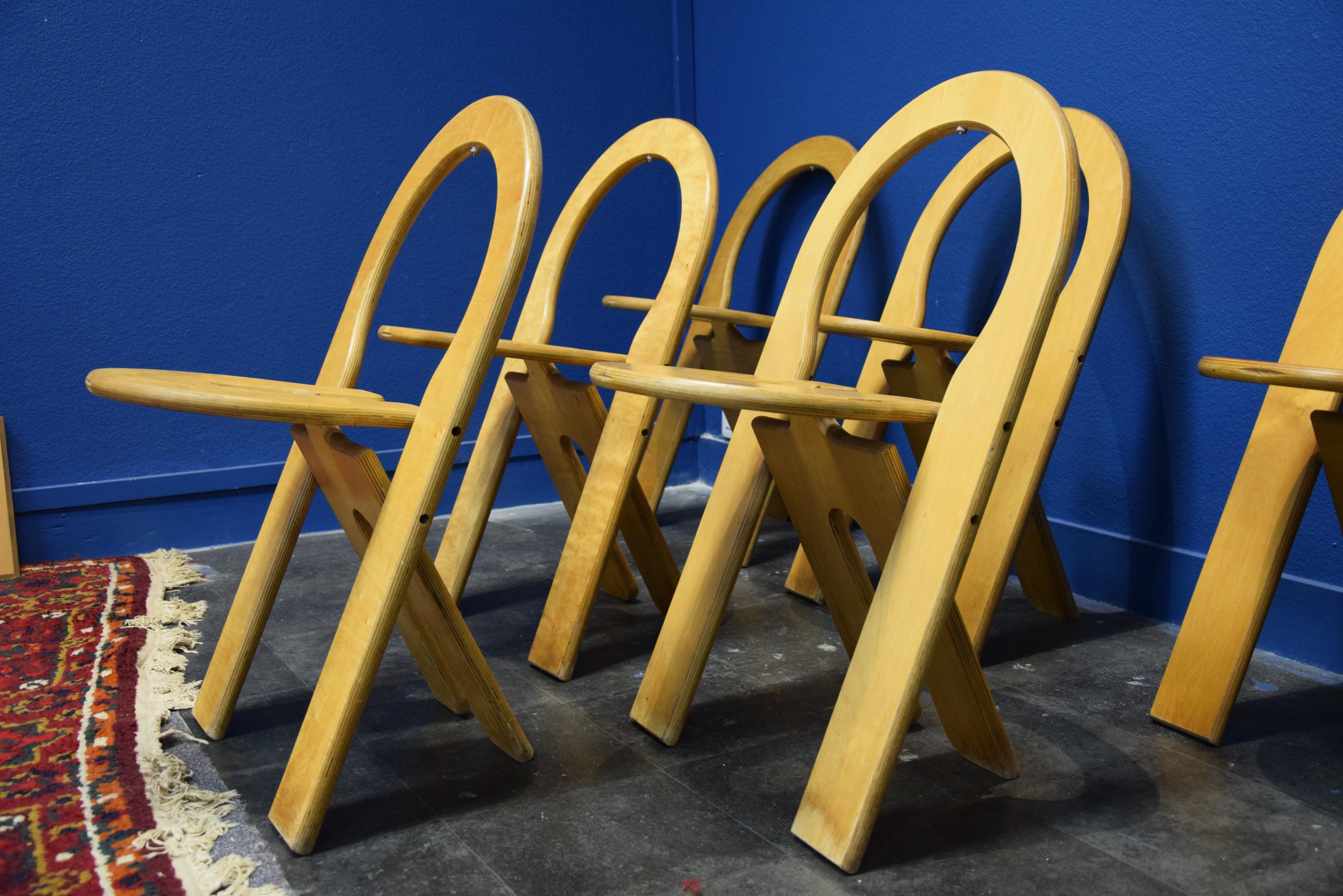 Set of six foldable chairs, in plywood, by Roger Tallon for Sentou, France, 1970s. 
Ingeniously designed chairs. 
Four maple stools, which can easily be placed and fold up.
The price is for 1 chair
6 chairs are available 
size closed