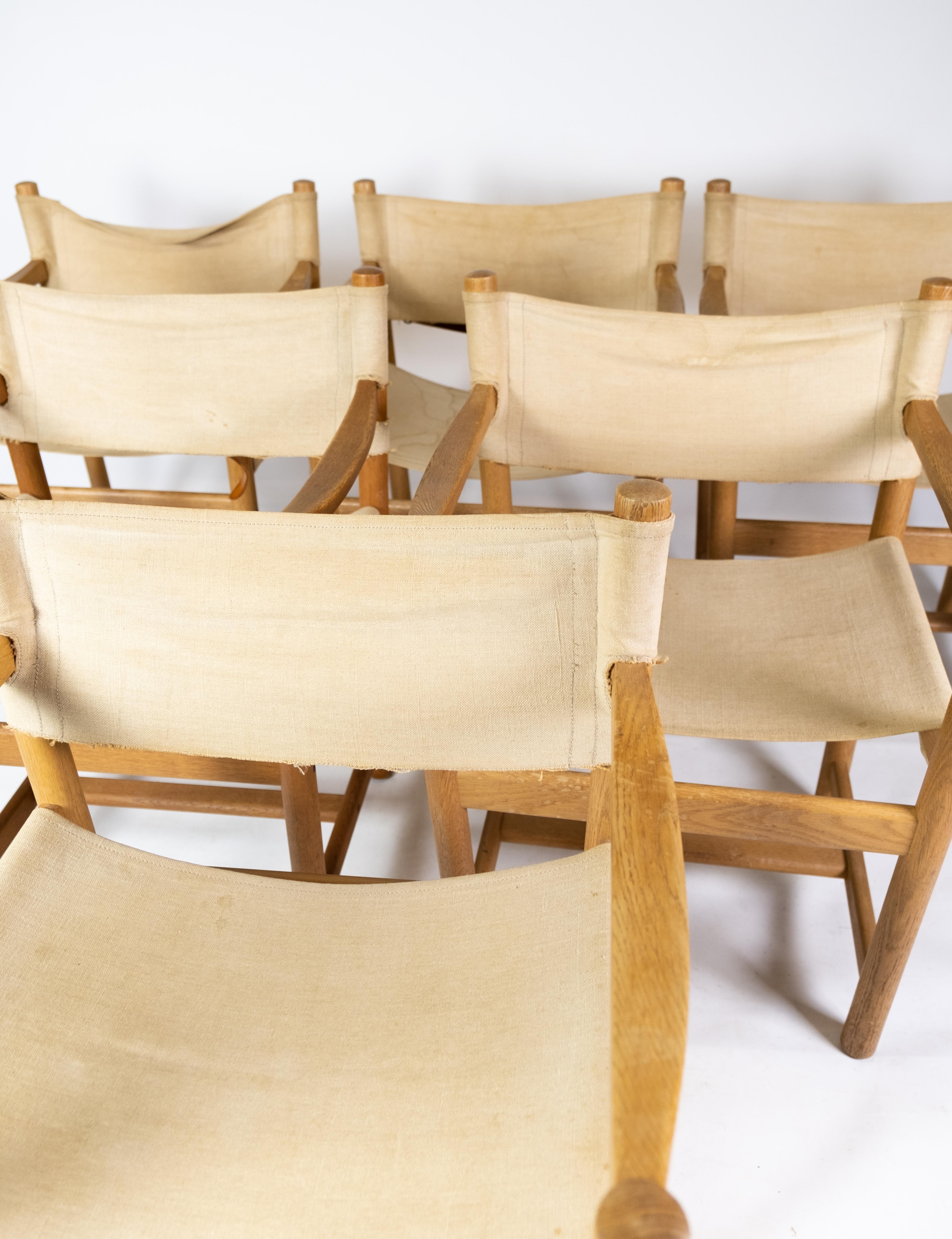 Set of six folding chairs, model J102, designed by Ditte & Adrian Heath for FDB Furniture from the 1970s. The chairs are of oak and light canvas.