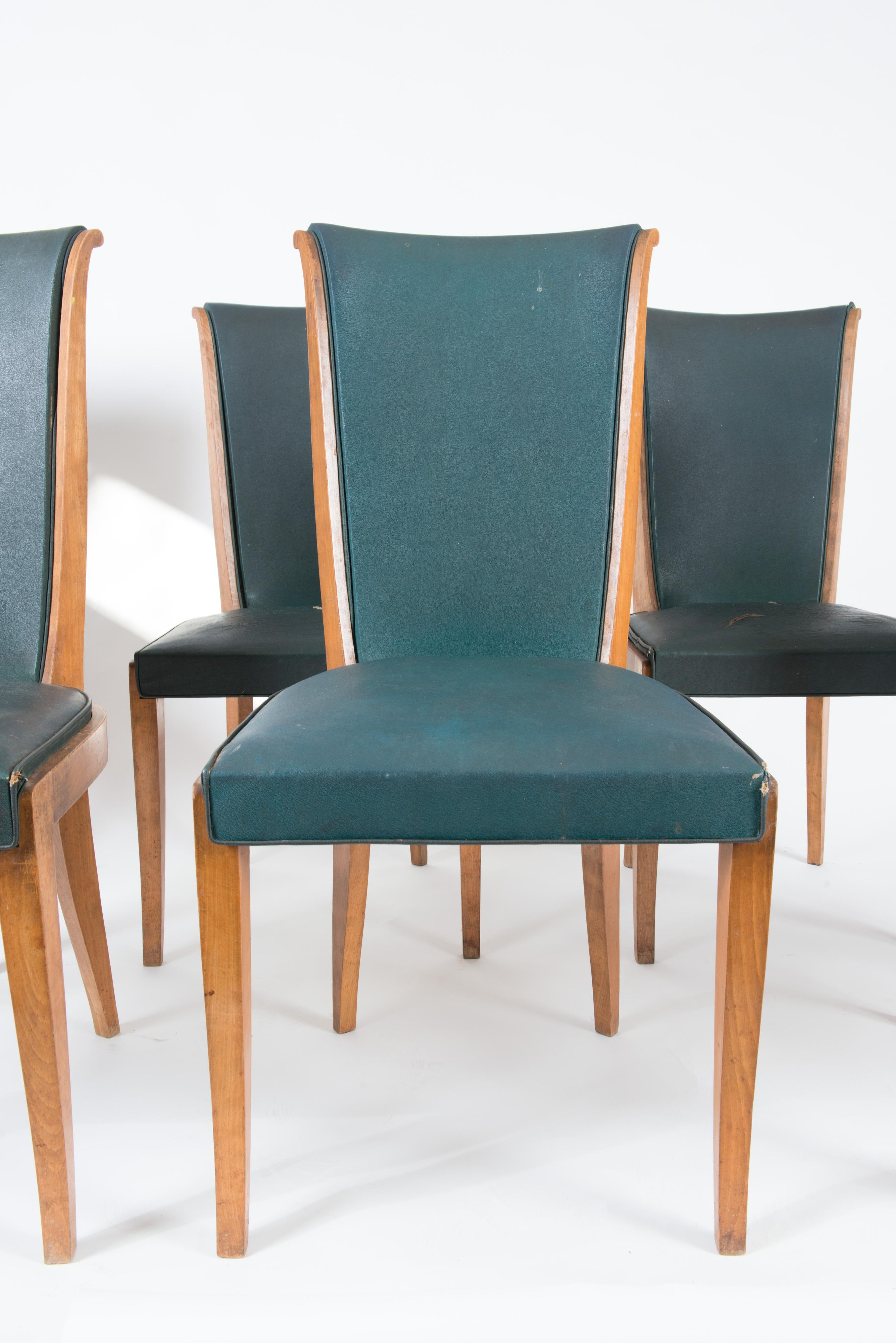 Set of six French midcentury light wood dining chairs. Frames are solid and sturdy. Original green vinyl upholstery. Ready for re-upholstery.
