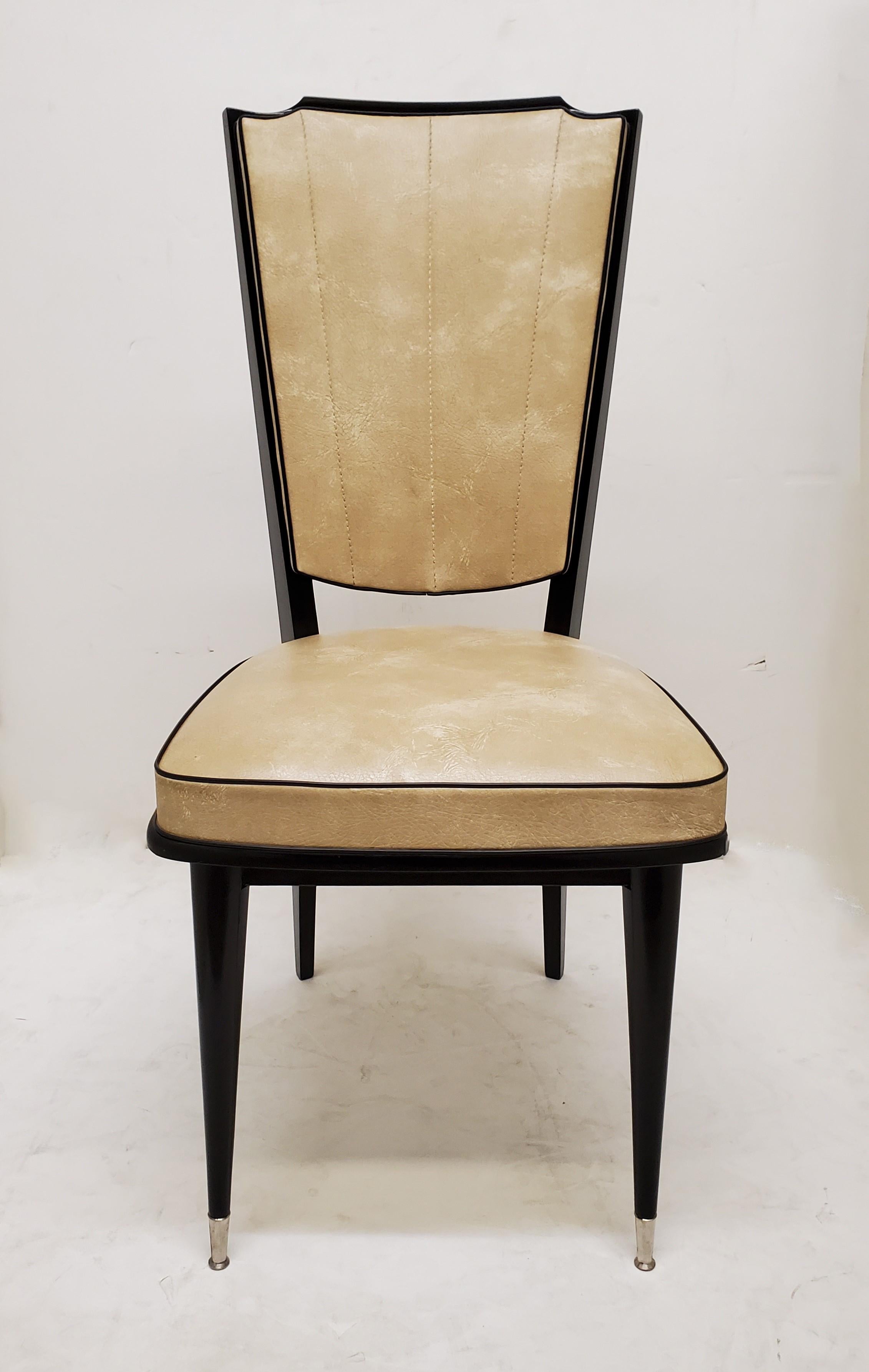 An original set of six French 1970's tall back ebonized wood dining chairs. 
Some of the chairs with original labels 