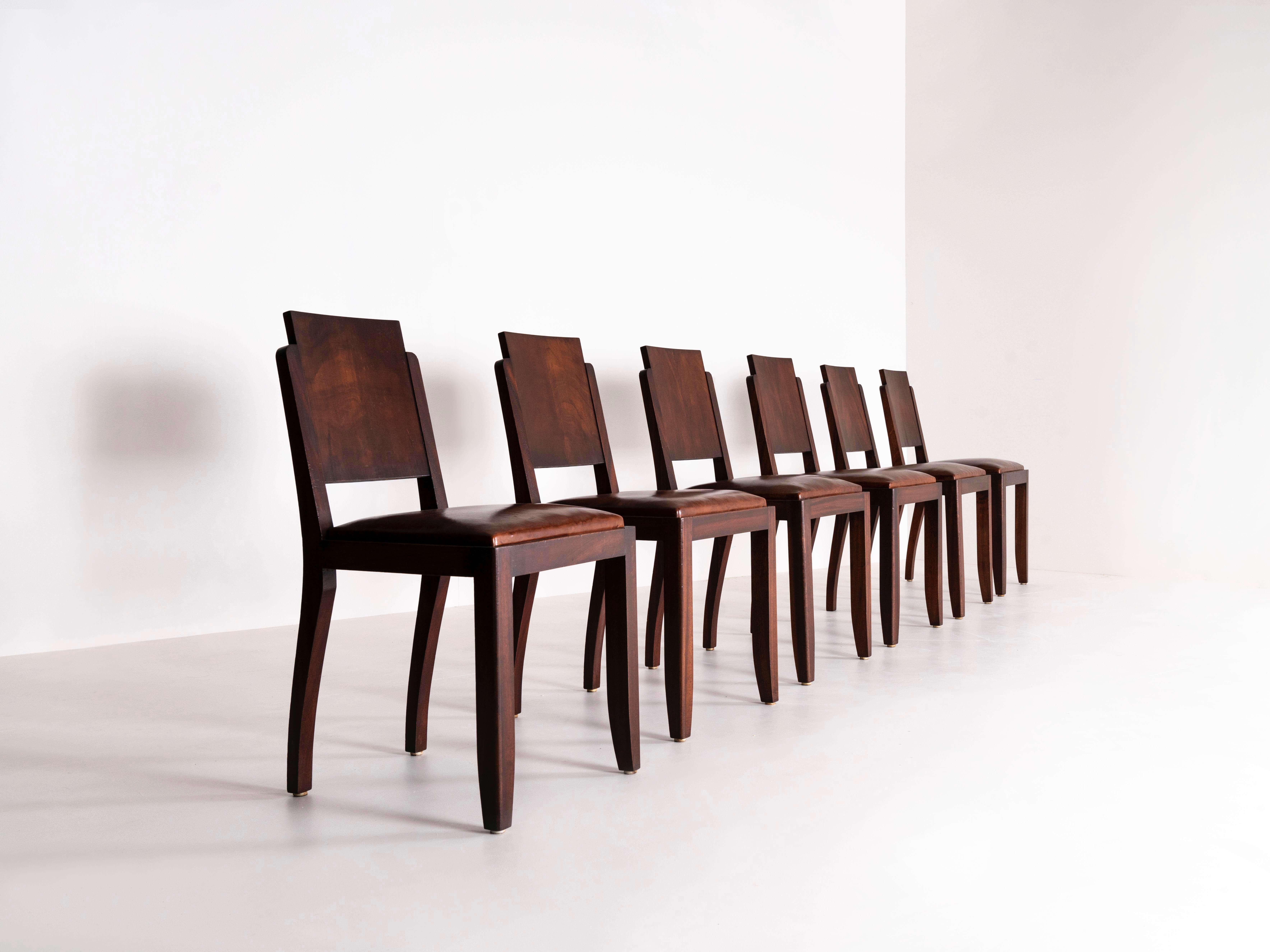 Amazing set of six French Art Deco dining chairs in the style of Michel Dufet, the 1920s. This set in mahogany has an amazing design, which is very recognizable for the French Art Deco design. It has a base in wood with sheep leather seating. The