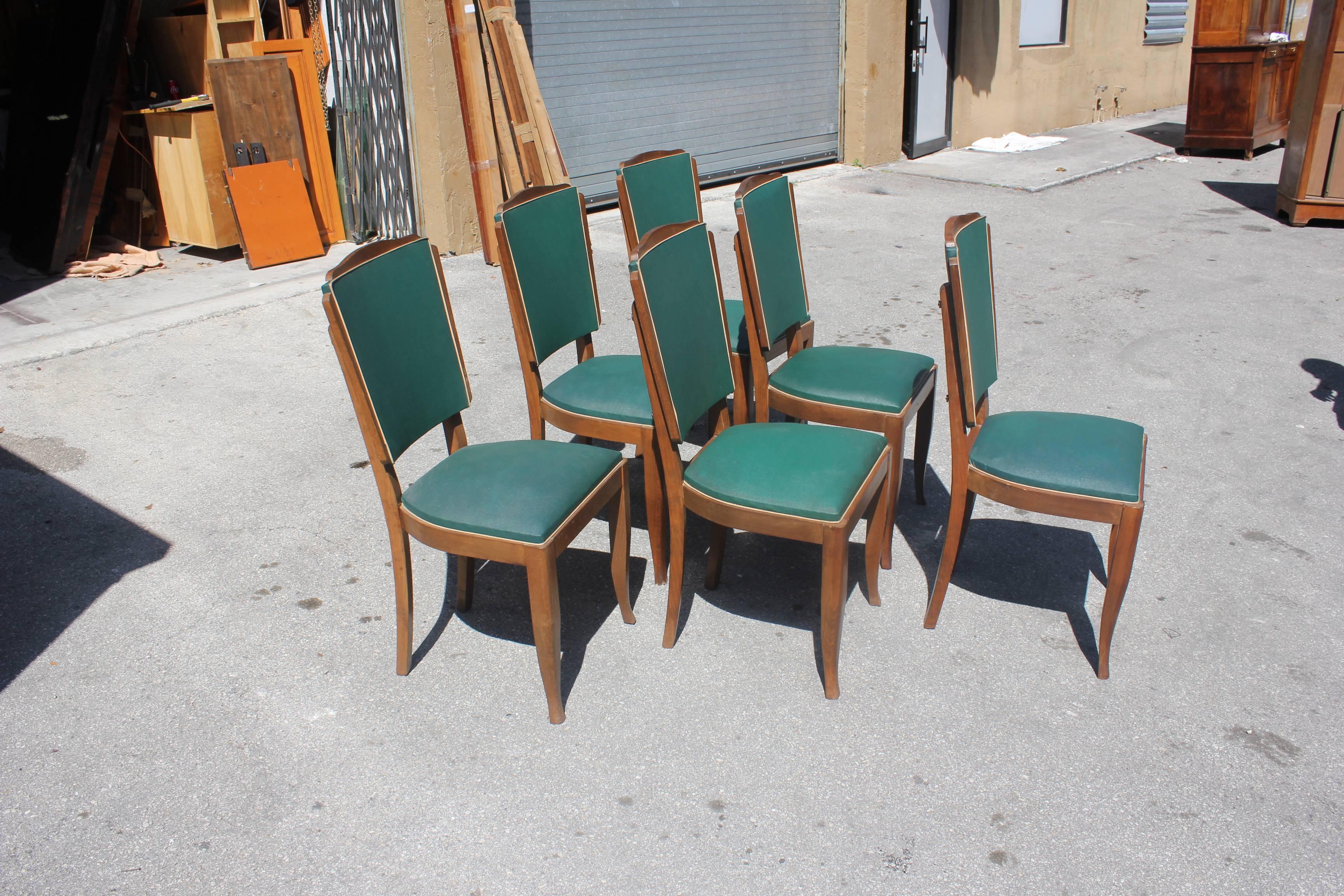 Set of six French Art Deco dining chairs solid mahogany by Jules Leleu style, chair frames are in excellent condition. Reupholstery is vinyl recommended for all six dining chairs, but the color green vinyl of the dining chairs are beautiful, circa