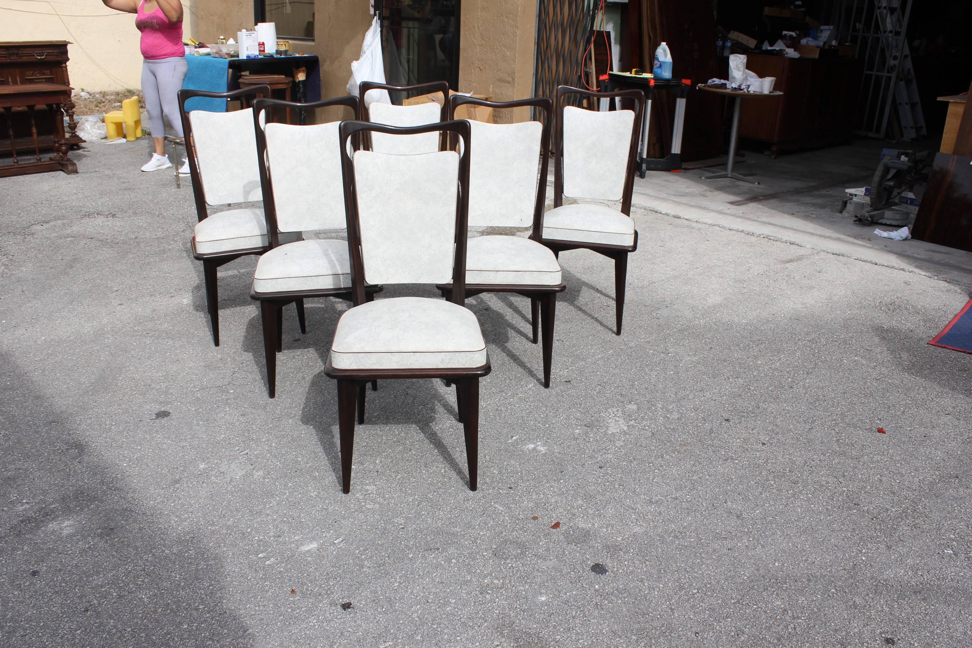 Set of six French Art Deco dining chairs solid Macassar ebony, the chair frames are in excellent condition. Reupholstery is vinyl recommended to be change for all six dining chairs, but the color of the dining chairs are beautiful, circa 1940s.