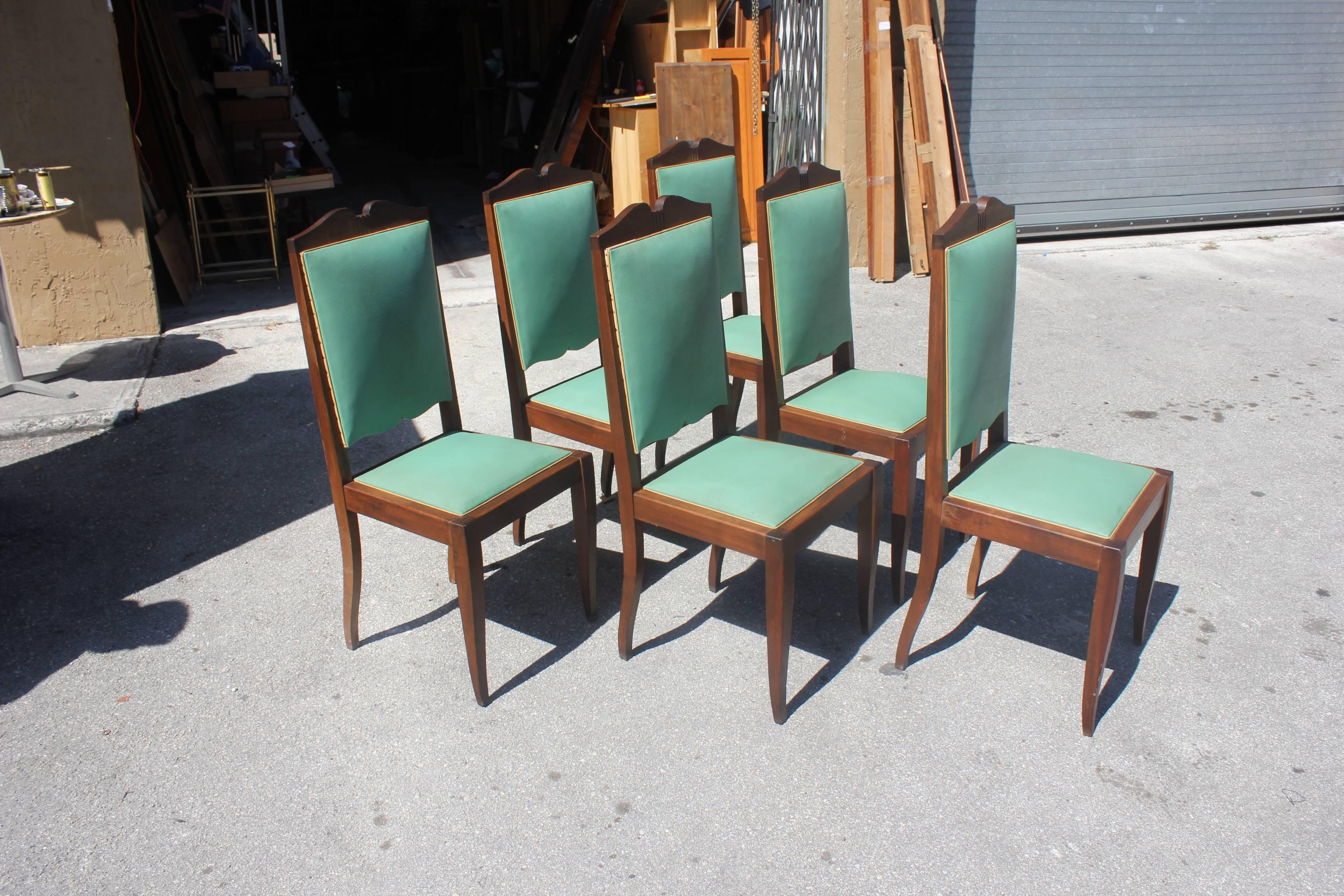 Set of six French Art Deco dining chairs solid mahogany by Jules Leleu style, chair frames are in excellent condition. Re-upholstery is vinyl recommended to be change for all six dining chairs, but the color green vinyl of the dining chairs are
