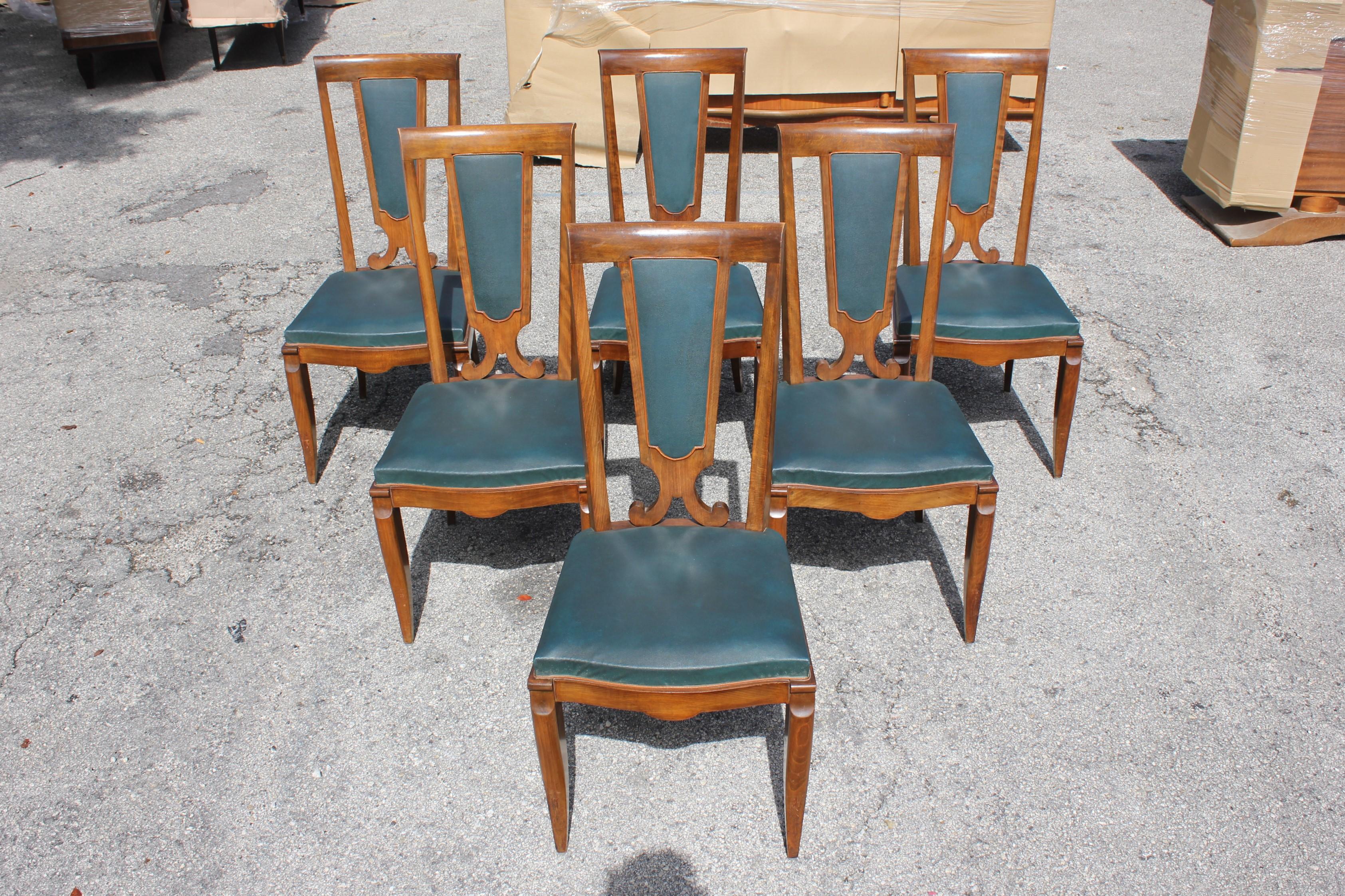 Monumental set of six French Art Deco solid mahogany dining chairs by Jules Leleu, the chair frames are in excellent condition. Reupholstery is vinyl recommended for all six dining chairs, but the color of the dining chairs are beautiful, circa