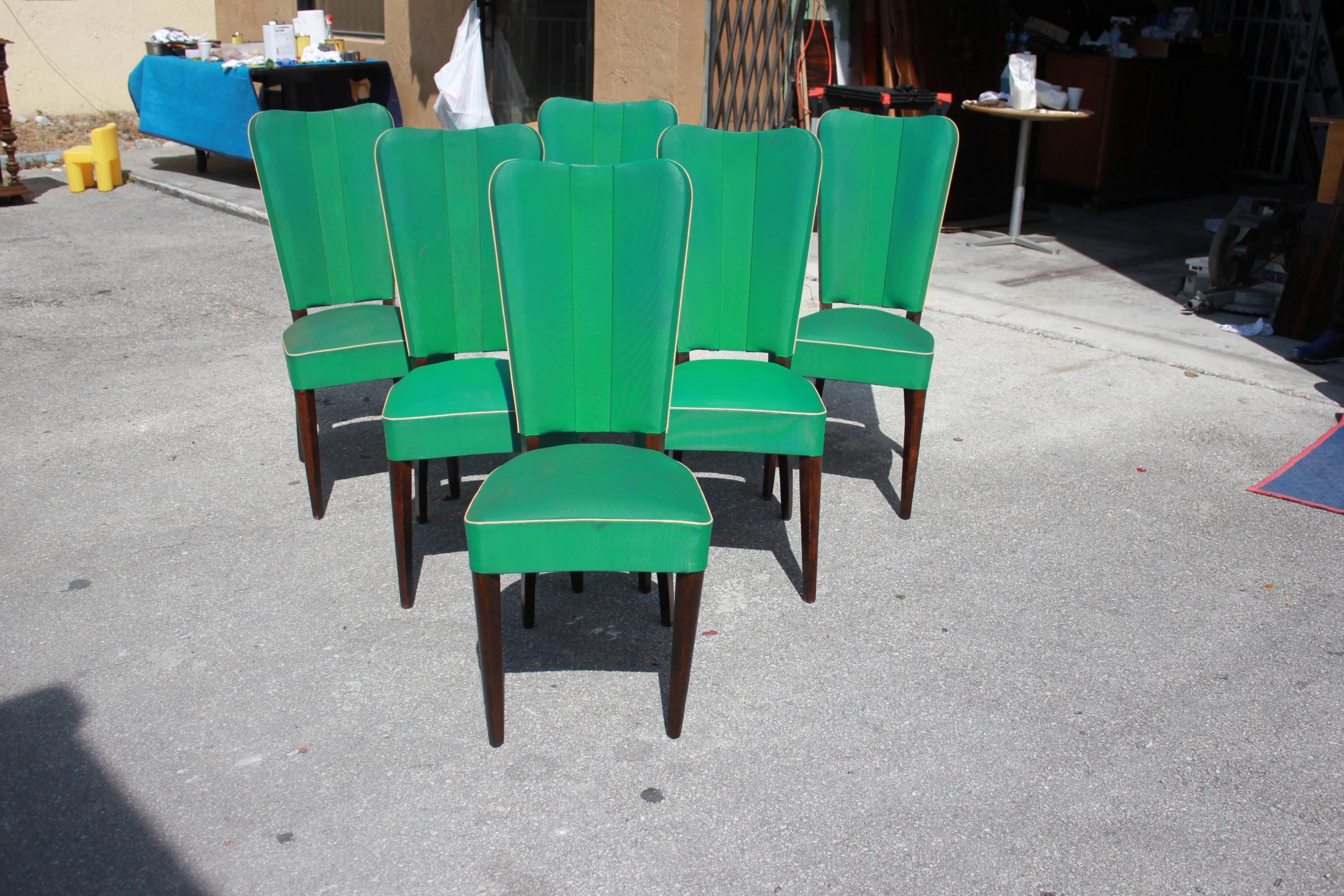 Monumental set of six French Art Deco solid mahogany dining chairs by Jules Leleu style; the chair frames are in excellent condition. Reupholstery is vinyl recommended for all six dining chairs, but the color of the dining chairs are beautiful,