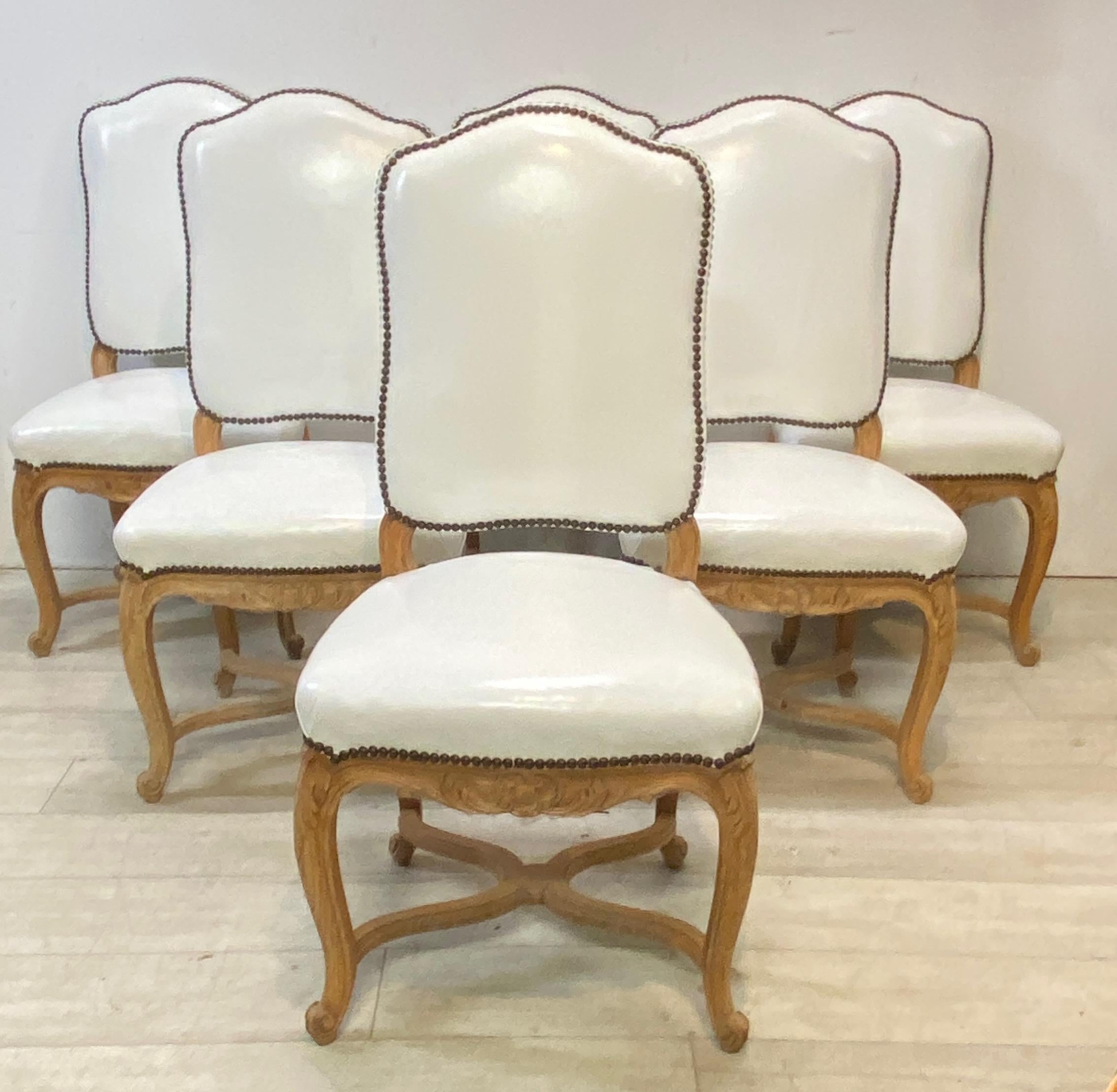 A set of six carved wood and white leather dining chairs. From the Calistoga California estate of the artist Ira Yaeger.
Chairs are sturdy and sound, with some minor indications of wear to the leather.
France, mid 20th century.
Ira Yeager is an