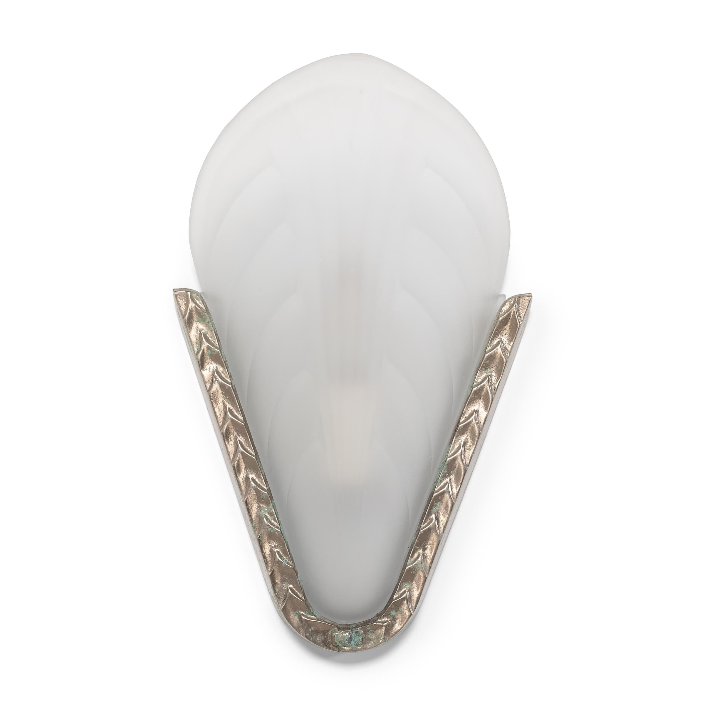 This charming set of early 20th century wall sconces exemplifies French Art Deco lighting with sculptural form and a soft, delicate appearance. The lights have frosted molded-glass shades resembling sea shells or flower petals, patterned with a