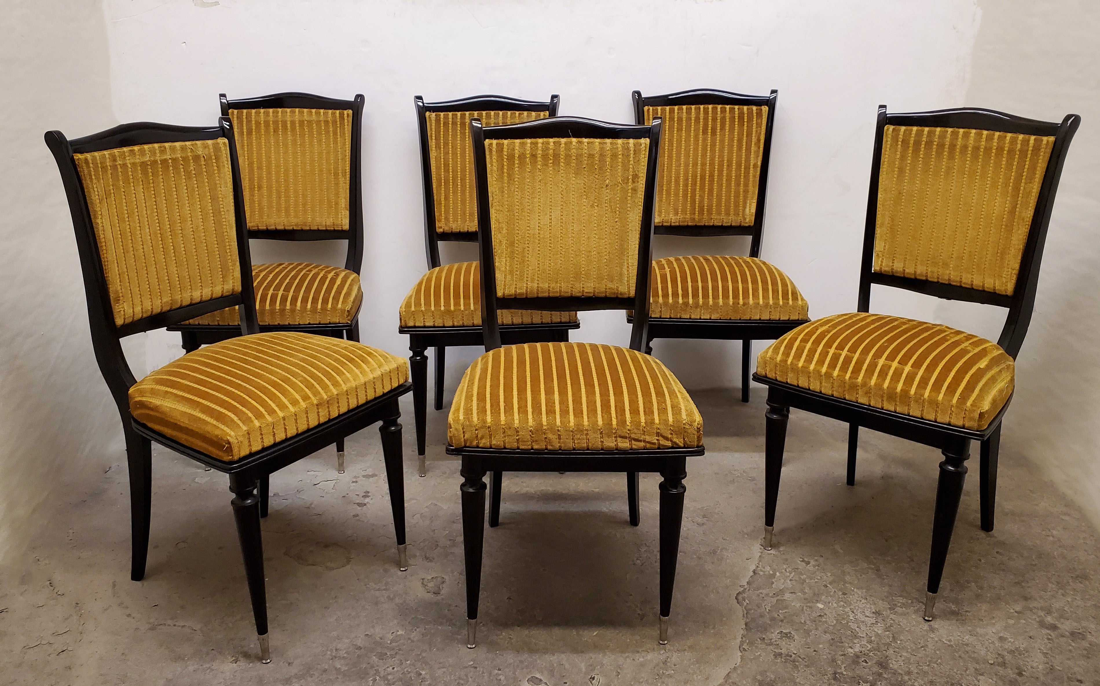 A set of six original French Modernist dining chairs featuring moustache shaped top crest , curved back rest, splay back legs and turned spindle front legs.
The chairs are streamline in overall shape and feature graceful nickeled bronze sabot tipped