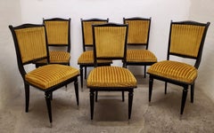 Set of six French ebonized dining chairs with nickeled sabots