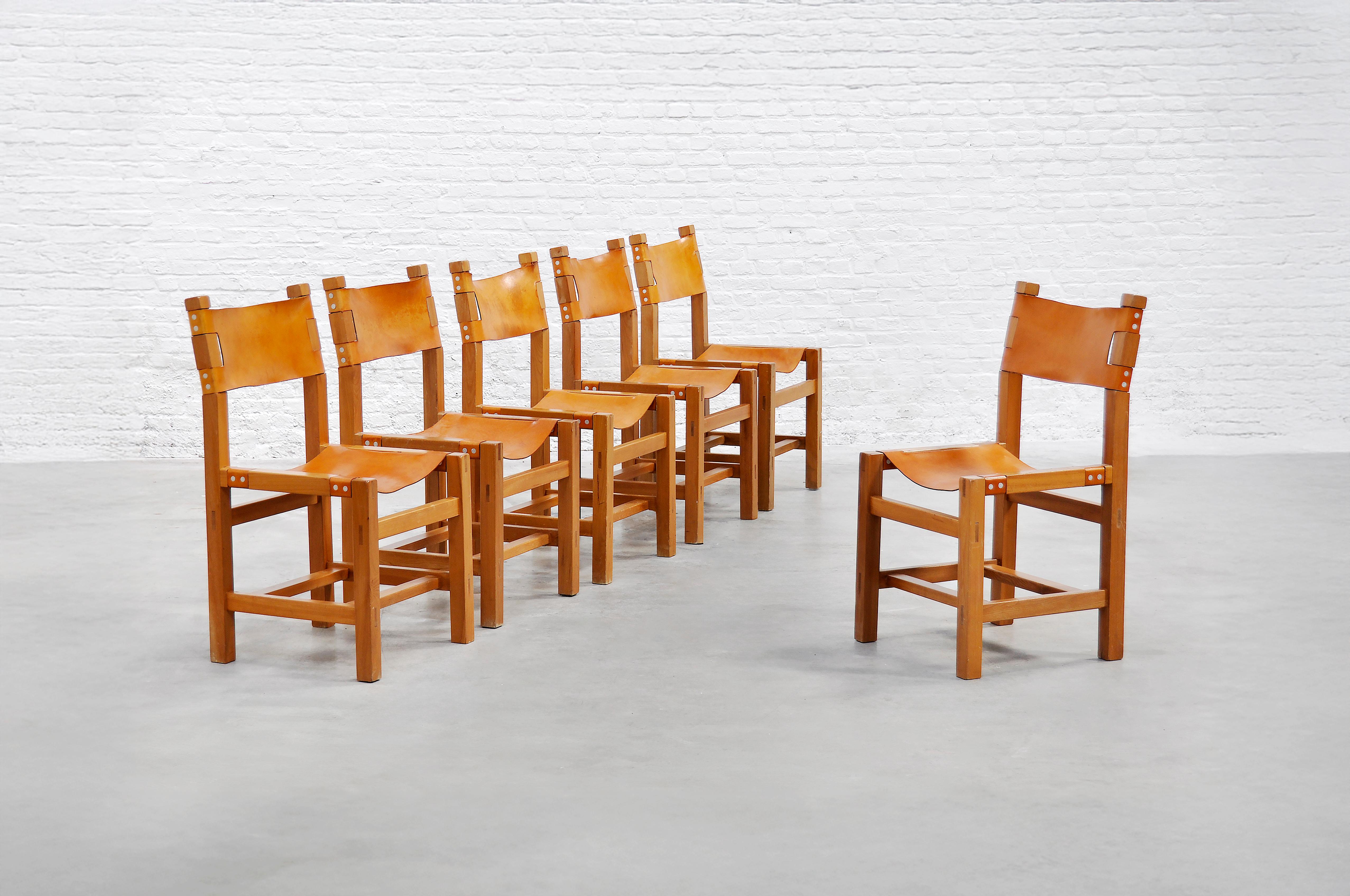This set of six brutalist dining chairs by Maison Regain showcases a refined balance of craftsmanship and materiality. Designed in the 1970s, each chair features a solid elm frame with clean lines and precise joinery, highlighting the natural warmth