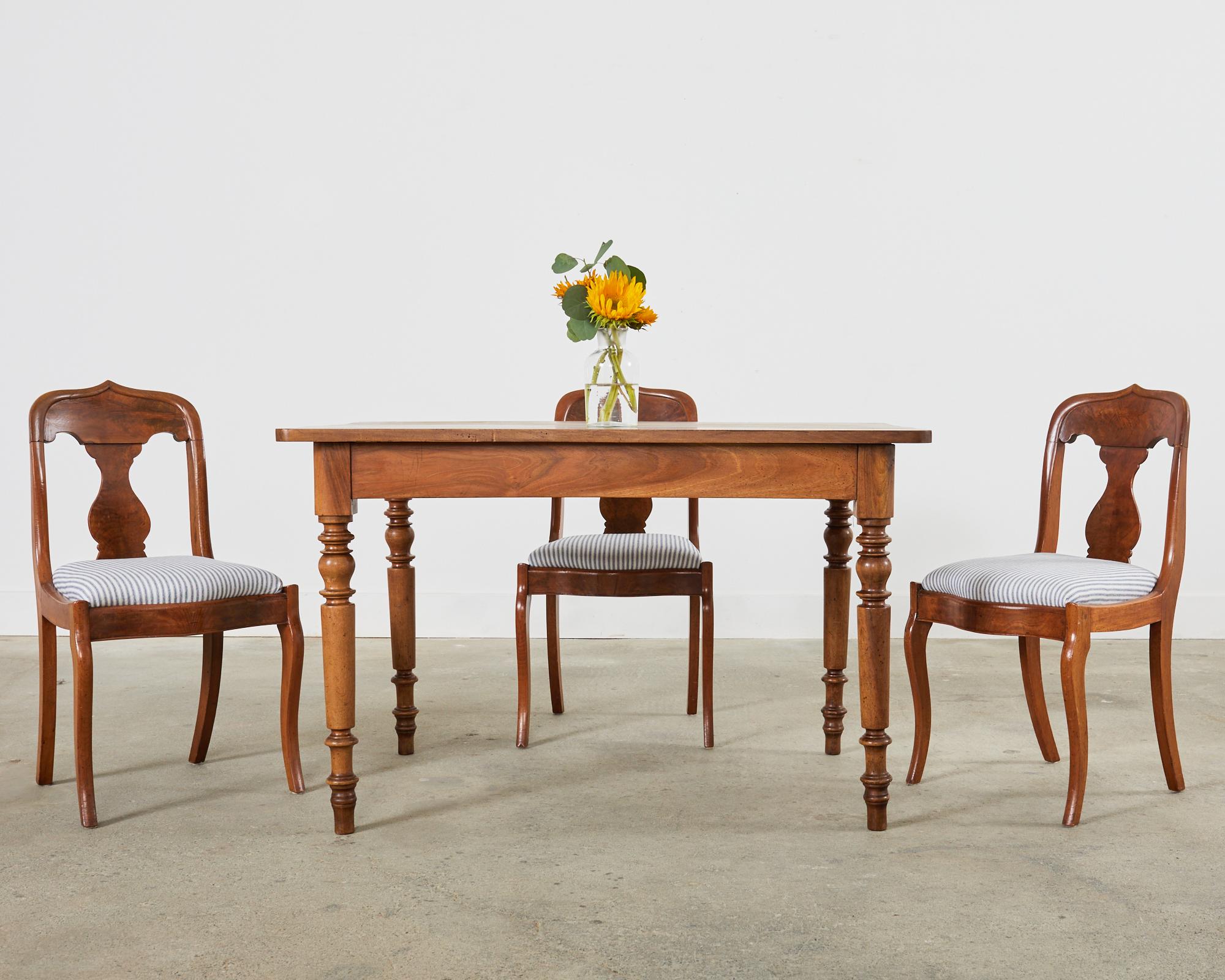 Distinctive set of six 19th century walnut dining chairs made on a slightly diminutive scale. The chairs are crafted from walnut and feature amazing radiant flame veneered seat backs, splats, and apron. The chair frames have a subtle gondola style