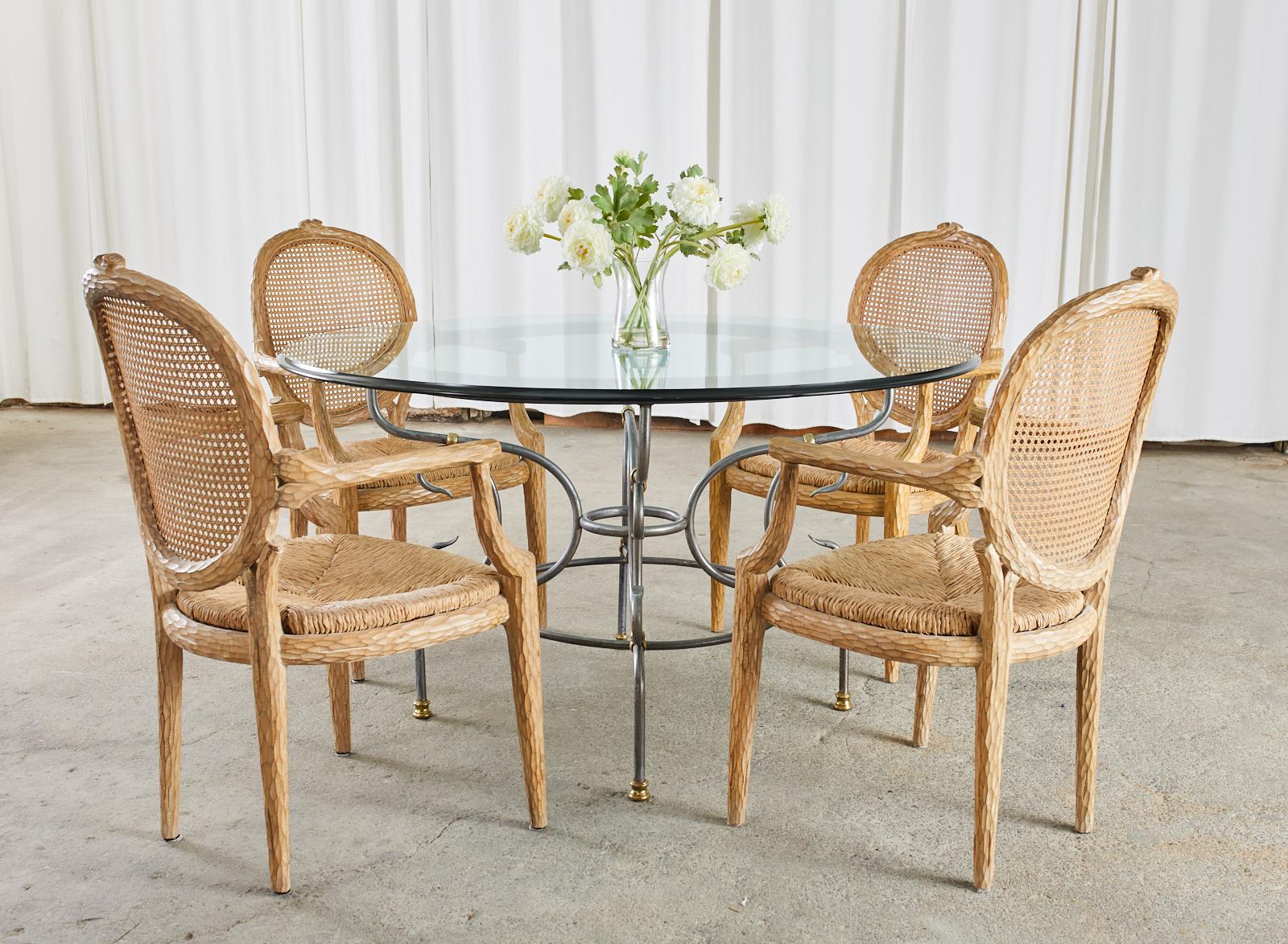 Exquisite set of six French dining armchairs crafted from hand-carved beech frames with a faux bois or twig motif. The chairs feature a round cane back inset and a rush seat bottom topped with a deep, newly upholstered loose seat cushion. The frames