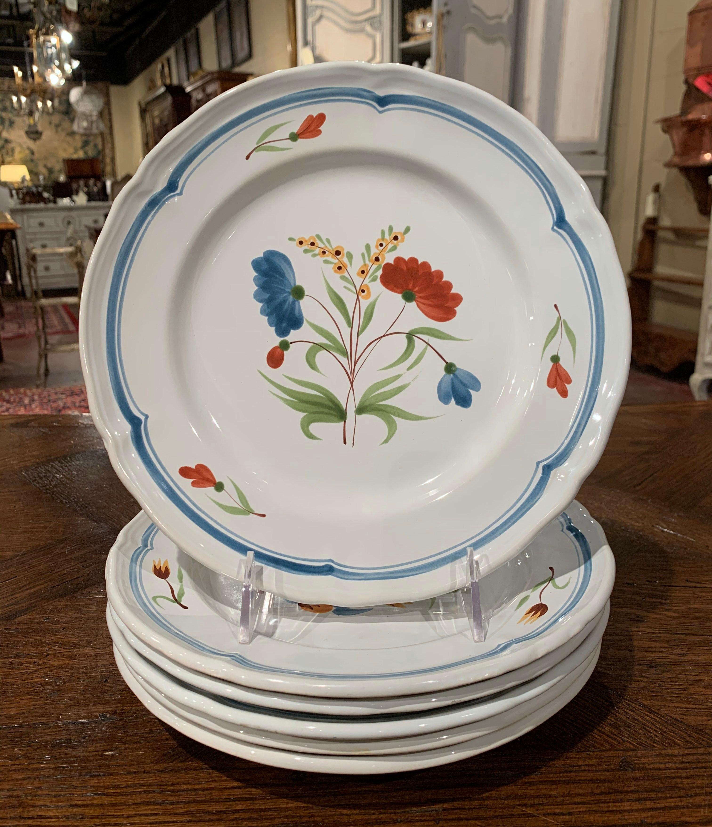 Decorate a kitchen wall or fill up a decorative hutch with this elegant set of hand painted, ceramic plates. Crafted in Pornic, France circa 2000, each colorful plate is hand painted with floral decor. The faience plates are in excellent condition