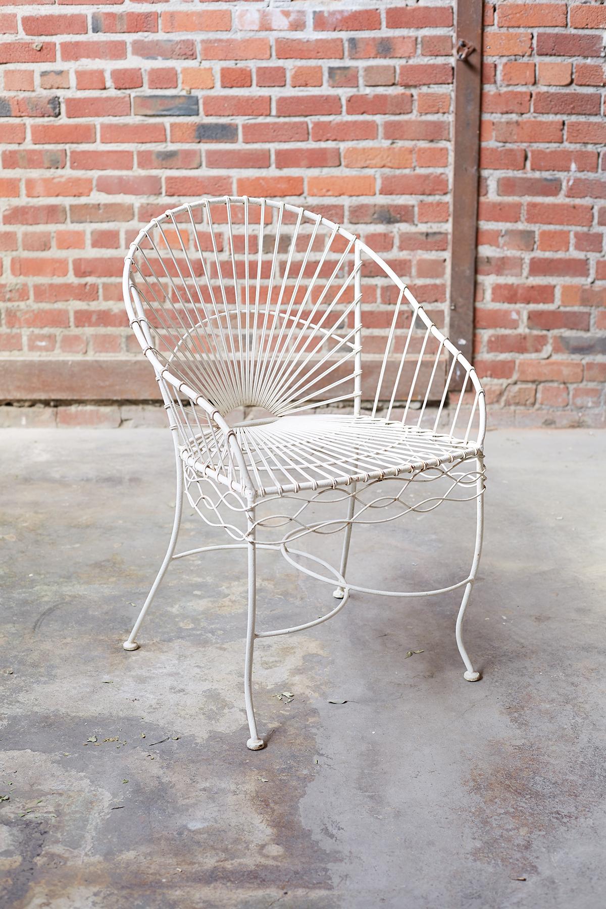 Fabulous set of six French painted iron and wire garden patio chairs. Featuring an iron frame decorated with twisted wire in a sunburst pattern on the back and seat. The sides have a wavy wire decoration and the legs are conjoined by overlapping C