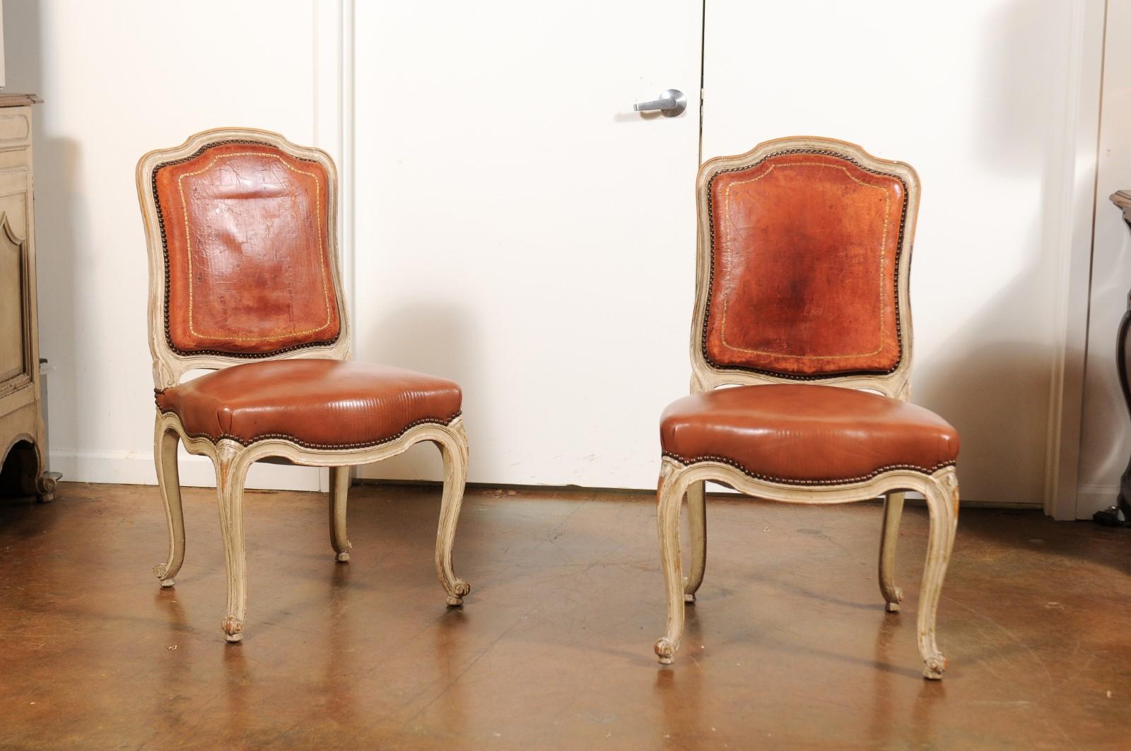 A set of six French shield-back dining room chairs from the 19th century, with brown leather upholstery and cabriole legs. Born in France during the ever-changing 19th century, each of this exquisite set of dining room side chairs features a padded