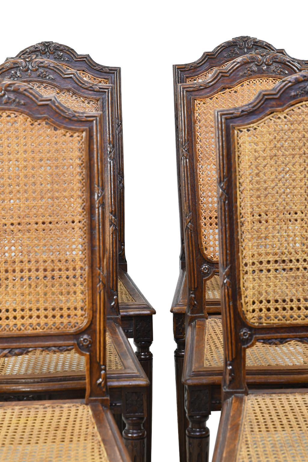 A beautiful set of six dining chairs in the French Louis XVI style with woven cane seat and back, with carved crest on arched back, and resting on turned and reeded legs. France or Belgium, circa 1880. Caning is in very good condition, and chairs