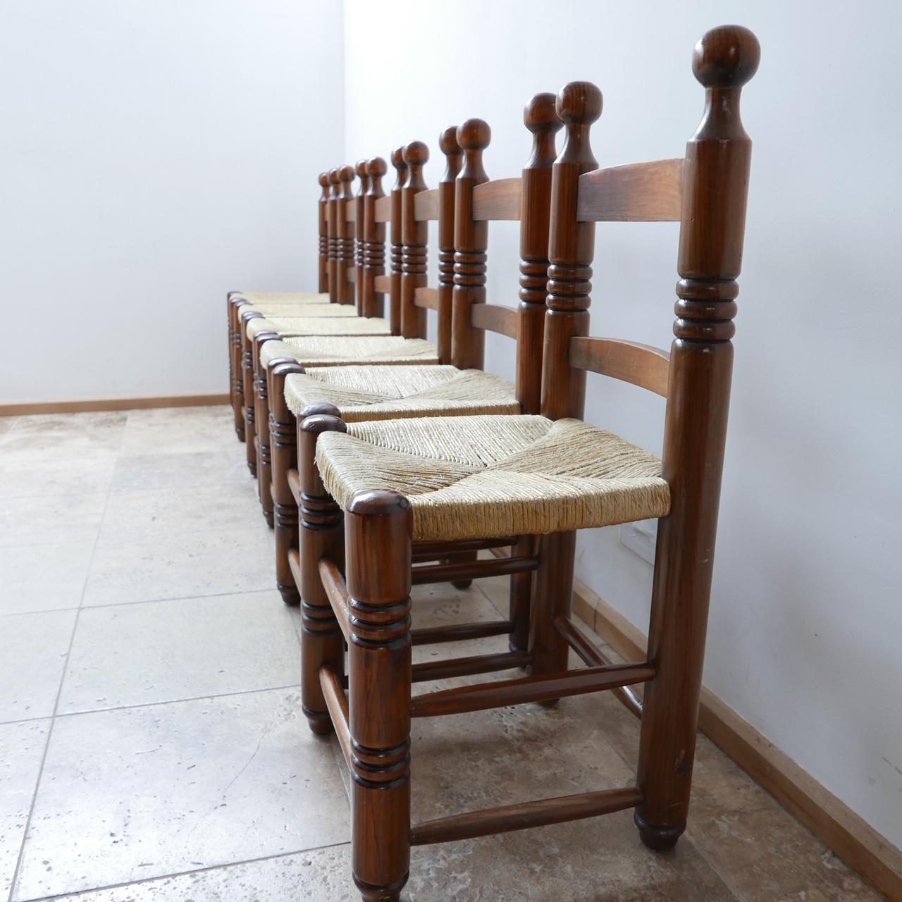 A set of six dining chairs. 

France, c1960s. 

In the manner of Charles Dudouyt. 

Original cord seat rests remain in good condition but have some signs of age. 

Lovely turned ball tops paired with the three sections of turned lines.