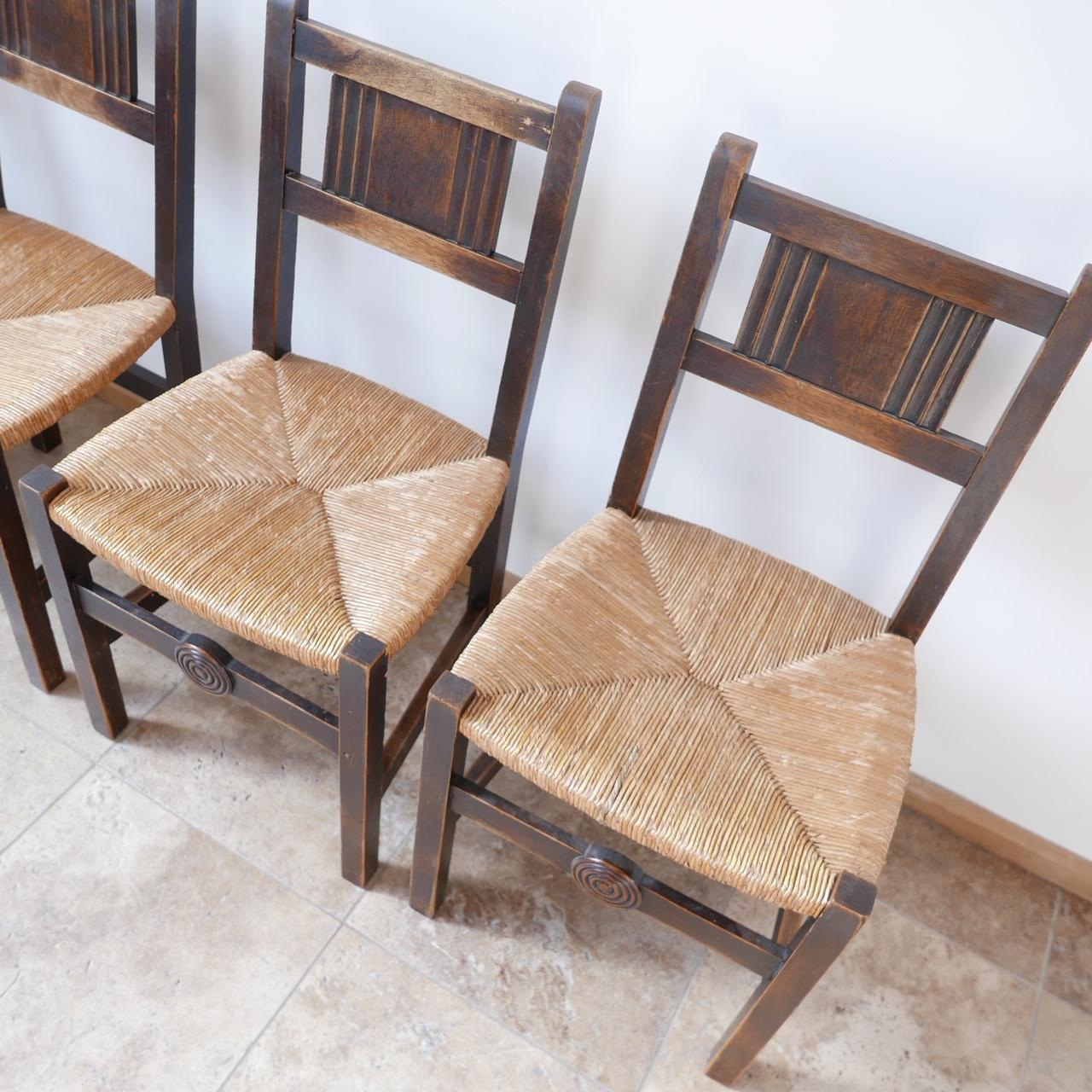 A set of six rush dining chairs. 

France, c1940s. 

In manner of Charles Dudouyt, with lovely ring detailing to base stretcher. 

Good condition. 

Patina and wear commensurate with age. 

Dimensions: 44 W x 43 D x 45 seat height x 87