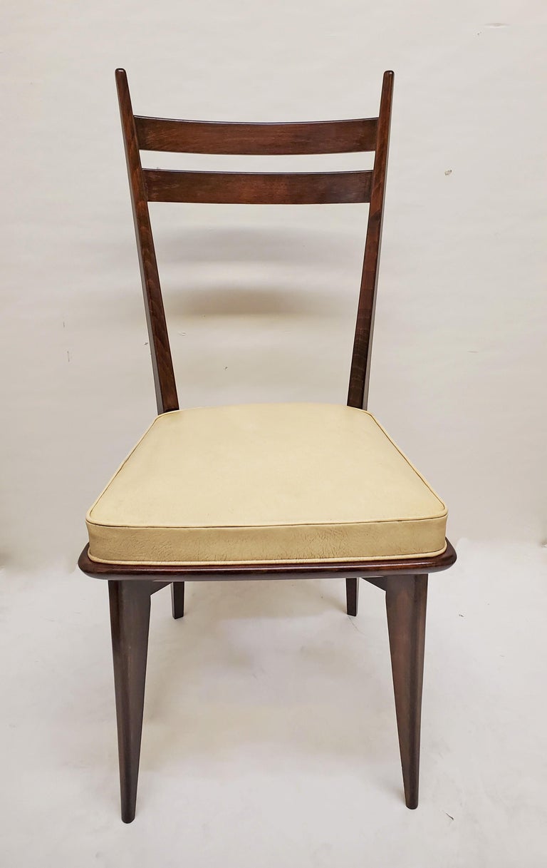 Set of six original French Modernist dining chairs featuring an open airy designed frame.
Tall backs with rounded vertical post and horizontal slats create a dramatic and aesthetic negative space between the wood top and the cushioned seat.
The